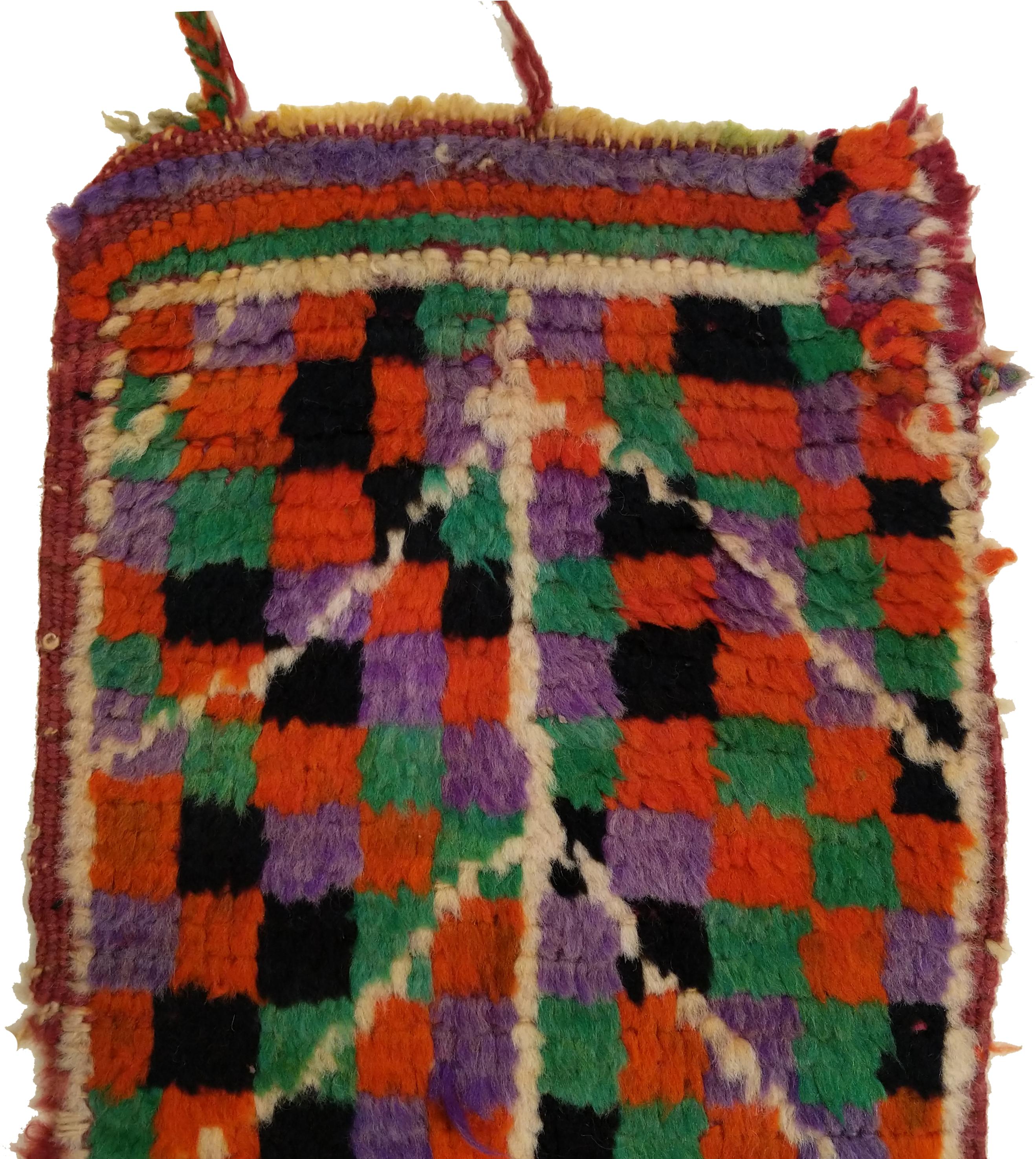 A very charming miniature Berber rug, obtained by unfastening the front panel of a piled pillow case. This was hand-crafted by the highly inventive weavers of the Ait Bou Ichaouen tribe, located in Talsint province very close to the border with