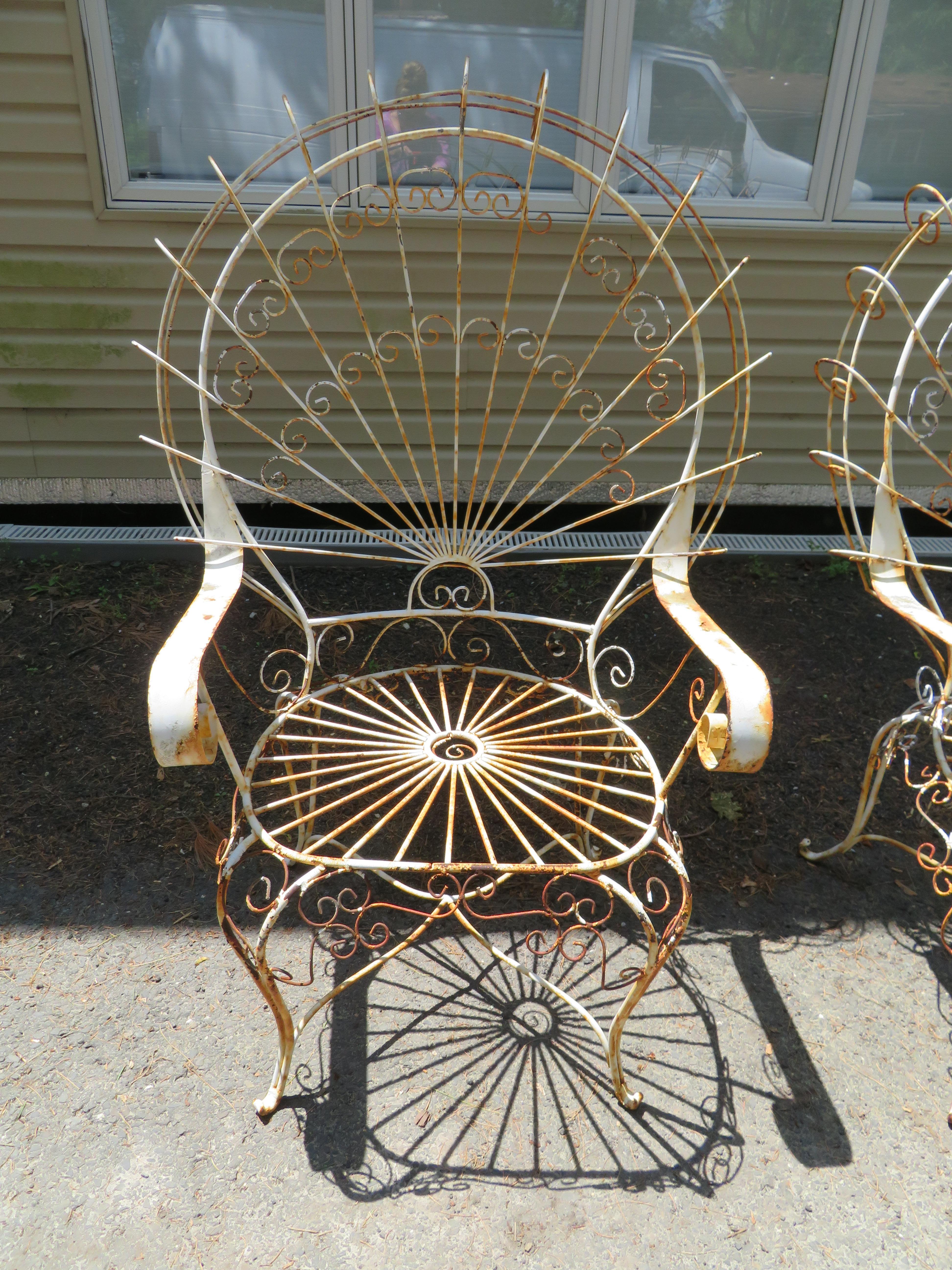 Charming pair 1960s John Salterini vintage midcentury wrought iron wire peacock chairs.
Victorian style chairs designed with a back pattern reminiscent of a peacock age appropriate patina. Please see our huge selection of other pieces from this