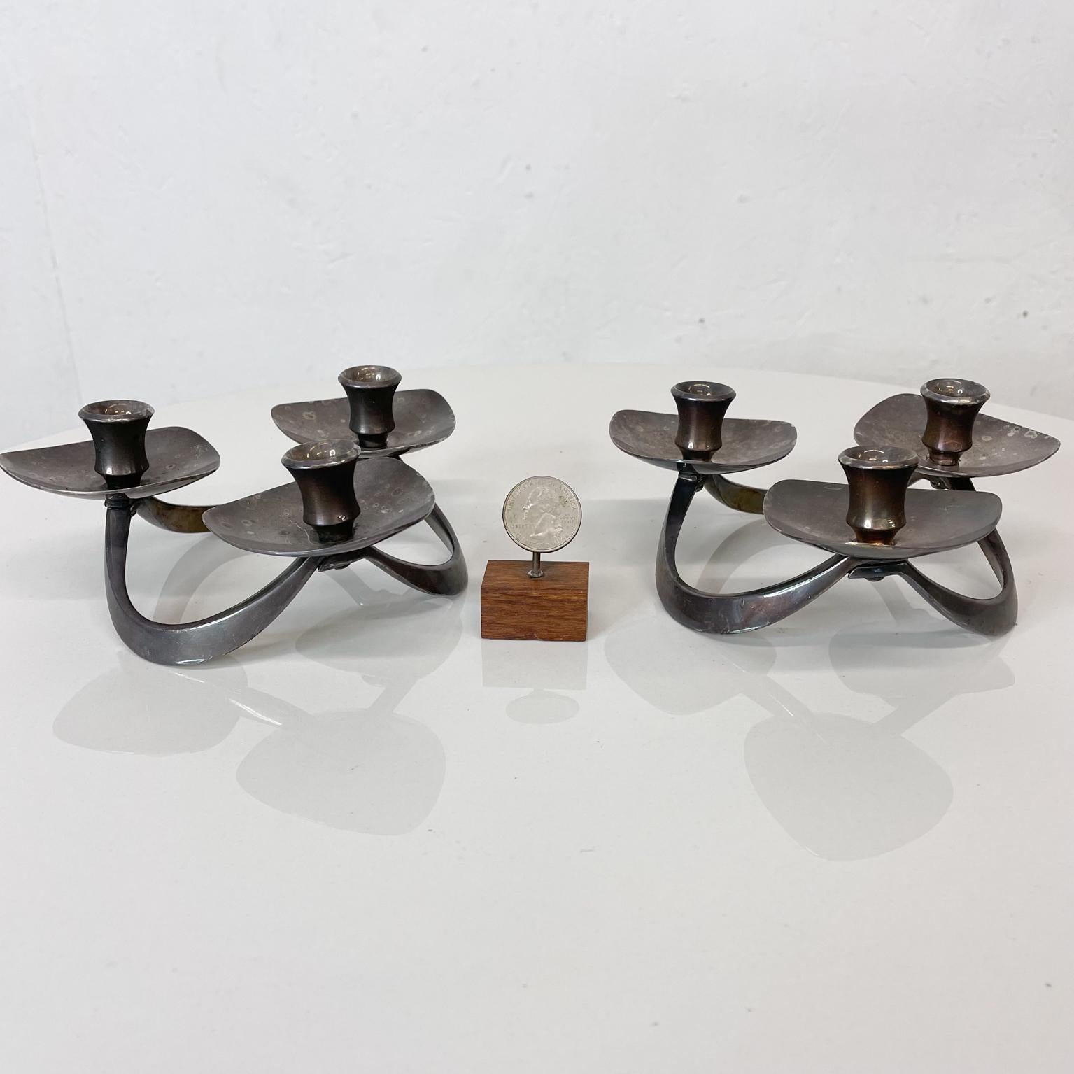 Candleholders by Lunt Silversmiths
Lunt Silversmiths Vintage Silver Plate Candle Holder Pair M-61- Set of 2- Three arm taper Candle Holders.
Midcentury Style Danish Modern 1960s
Made in Greenfield, Massachusetts
Candle diameter is .5