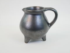 Charming pitcher on three feet in mat black ceramic