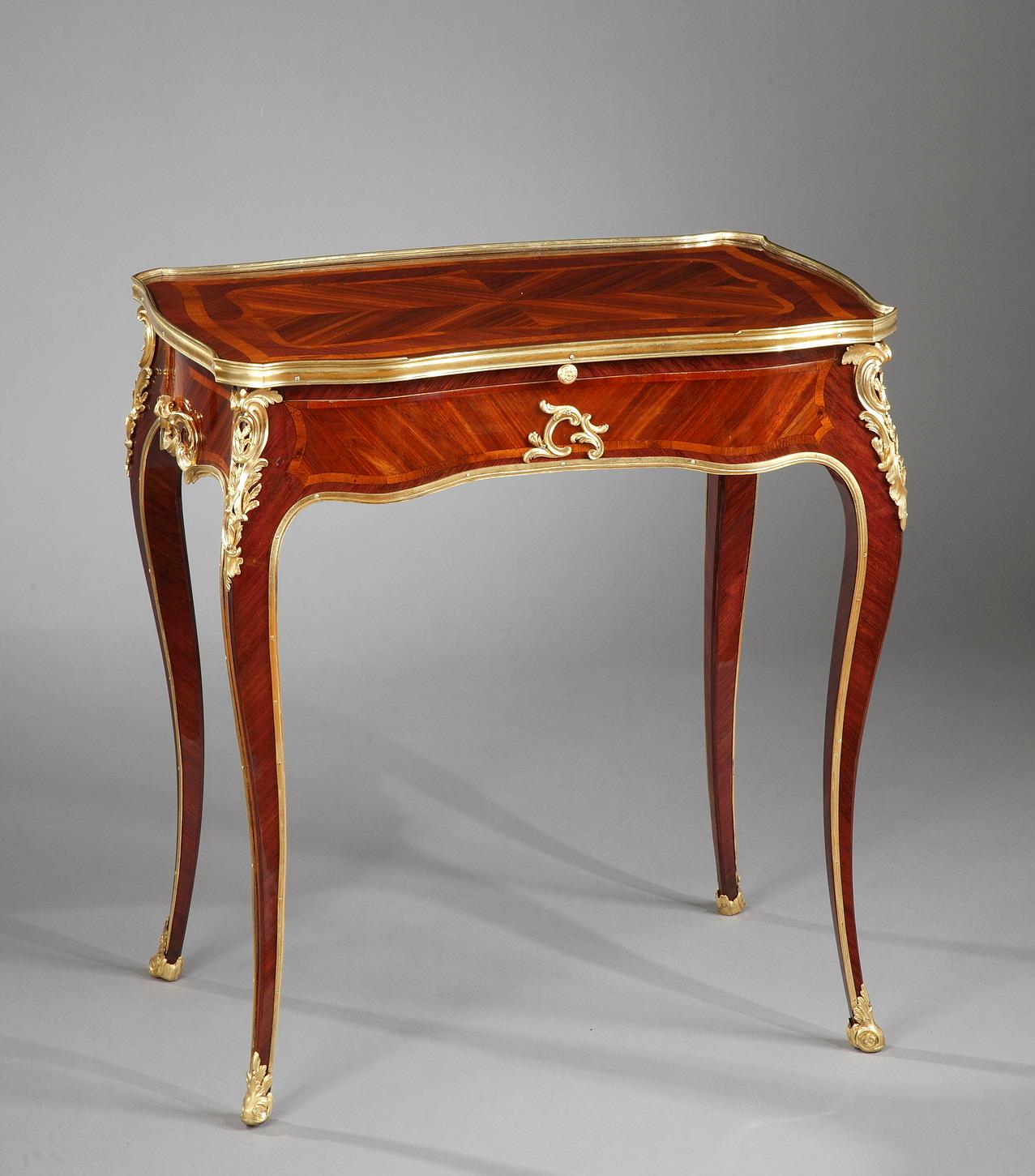 Charming Louis XV style reading table attributed to H. Dasson. It opens on one side by a compartmental drawer and by a sliding shelf, forming a writing board and being able to switch to a reading position. Its tray in veneered wood is circled by a