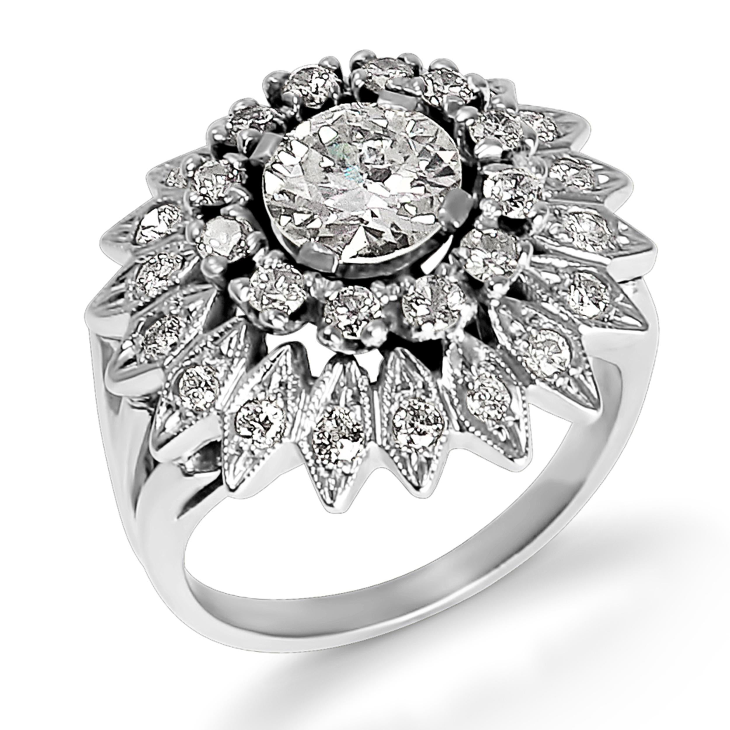 This sensational cocktail ring is a one of a kind statement piece! Featuring a 1.50 carat round diamond, the center stone is surrounded by a halo of 2.00 millimeter round diamonds. The magnificent starburst halo is detailed with millgrain and 1.5