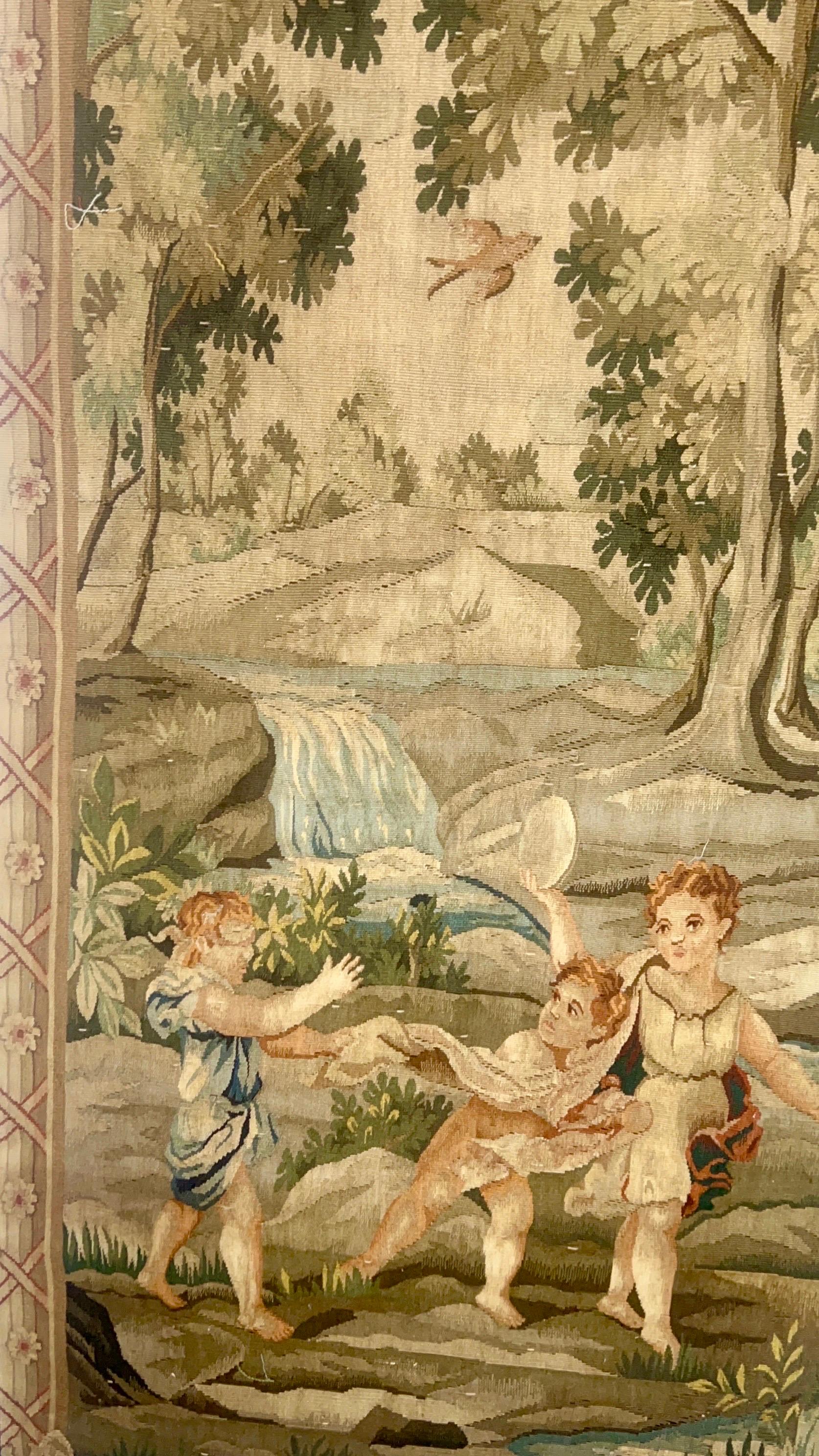 Belgium and french fine quality wall tapestries are a woven wall hanging that depicts a scene or famous painting.  This tapestry features a pastoral scene. 
In the foreground there are a group of children playing in a field.  The detailed work