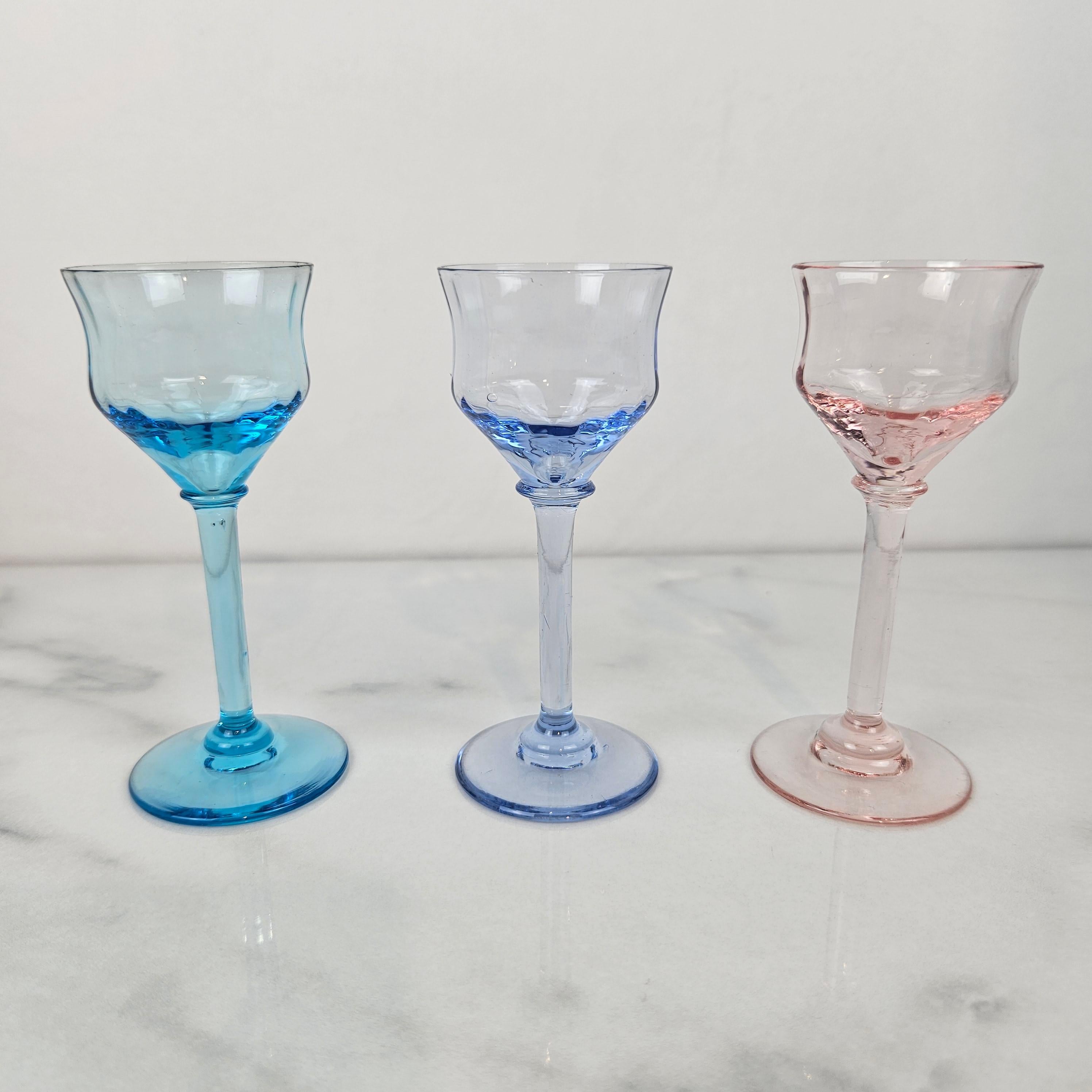 Un ensemble sophistiqué de 3 verres à liqueur Art déco des années 1920, chacun soufflé à la main dans un verre bleu entièrement coloré. 
Parce que la couleur fait partie intégrante du verre lui-même - elle n'est pas peinte ou flashée - chaque pièce