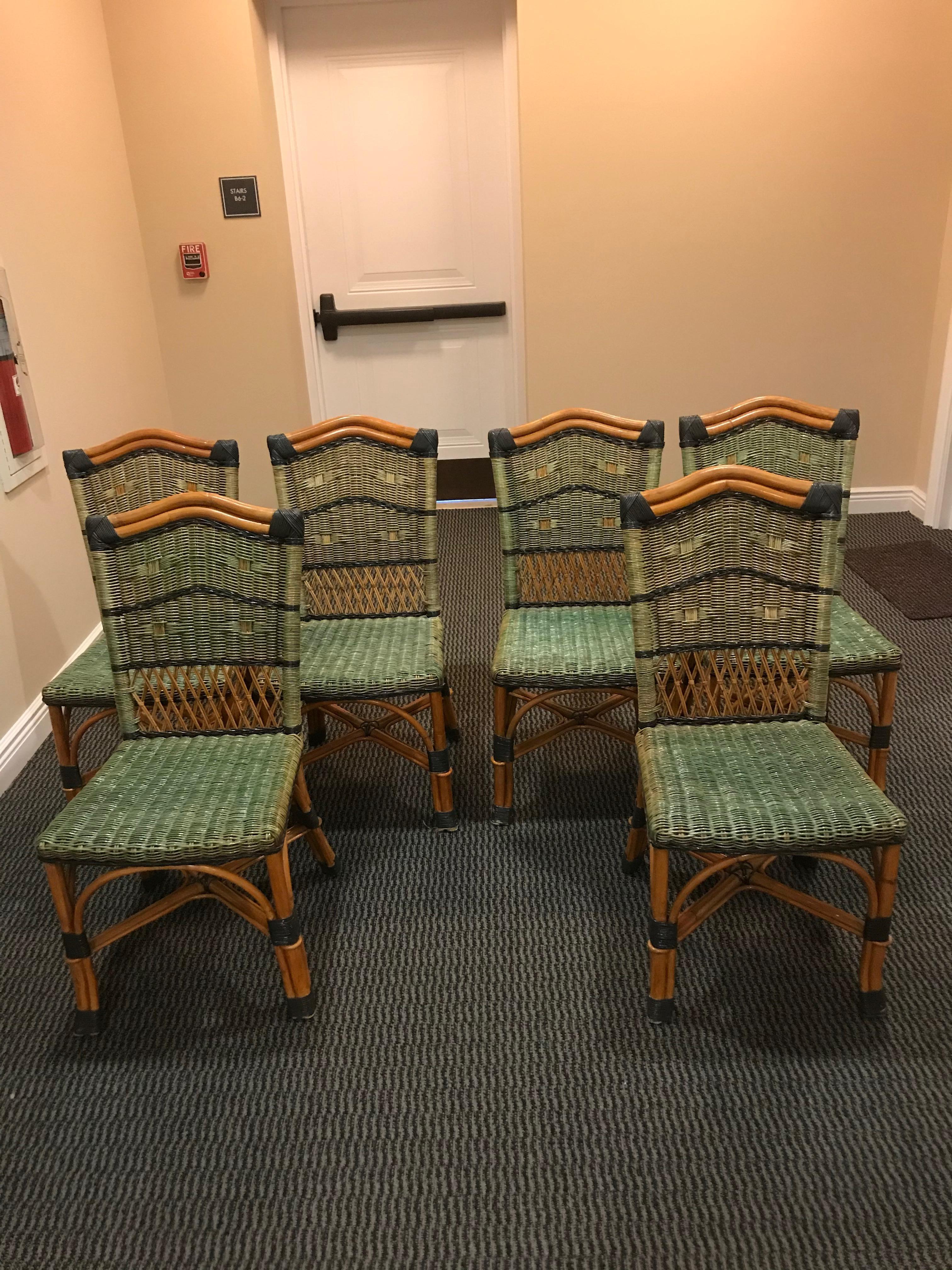 A stunning set of 8 Grange rattan chairs from the 1970s are an inviting color combination of natural honey colored wood with dark and light green on seats. The coiled rattan on legs is dark green.
6 sides and 2 arm.
Side chairs measure: 37” H, 18”