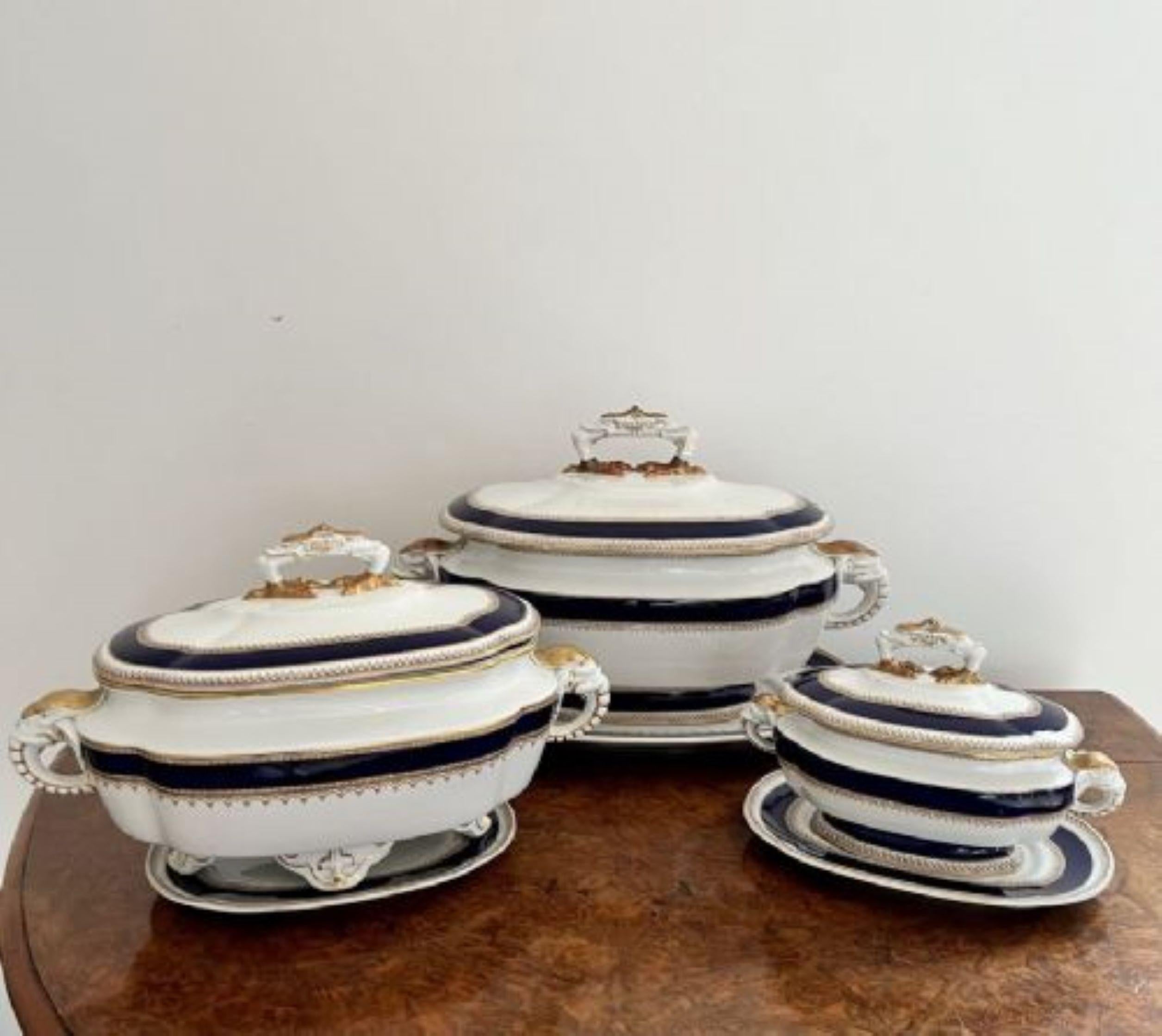 Charming set of three Antique Royal Worcester tureens having three antique Royal Worcester tureens, decorated with gold floral transfer patterns bordered by dark blue on a cream ground having elephant head handles to the sides and gold chickens feet