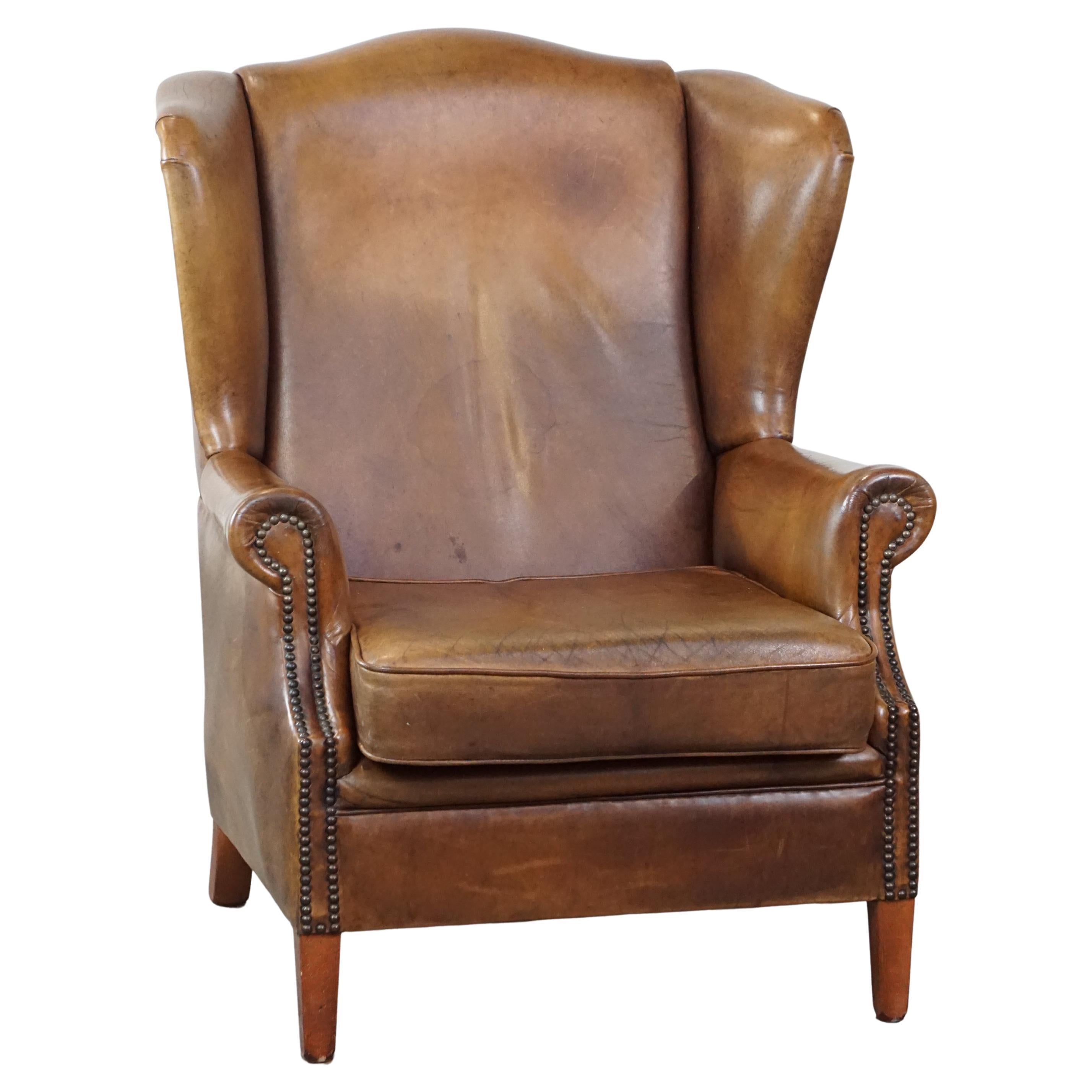 Charming sheep leather wingback armchair with an excellent seating comfort