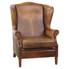 Graziosa poltrona wingback in pelle di pecora con un eccellente comfort di seduta