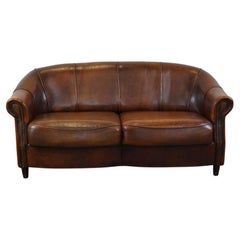 Charming sheepskin leather 2-seater sofa with fixed seat cushions