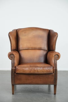 Charming sheepskin leather wingback chair with warm colours