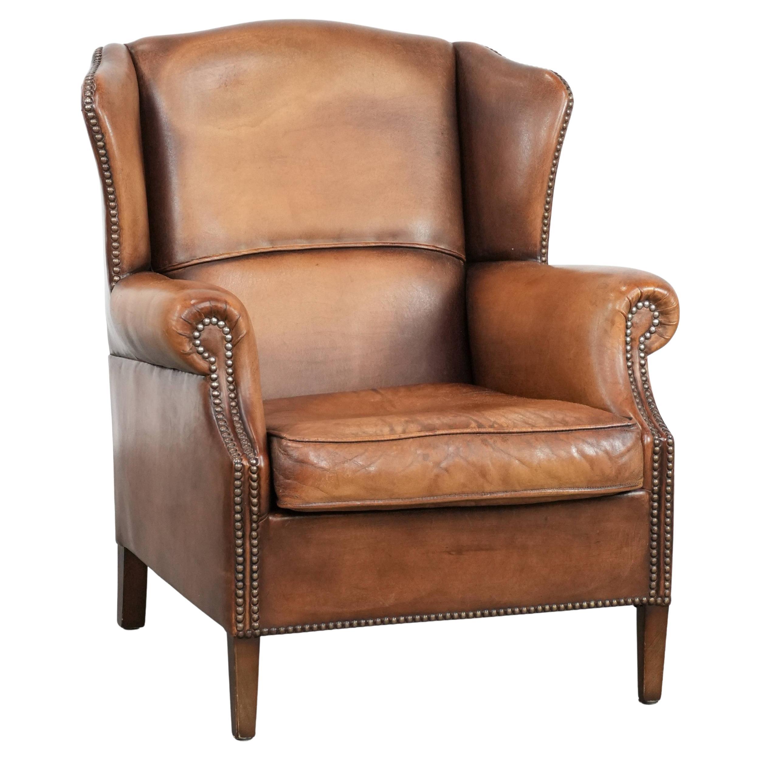 Charming sheepskin leather wingback chair with warm colours For Sale