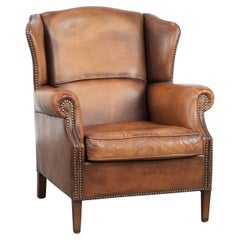Charming sheepskin leather wingback chair with warm colours
