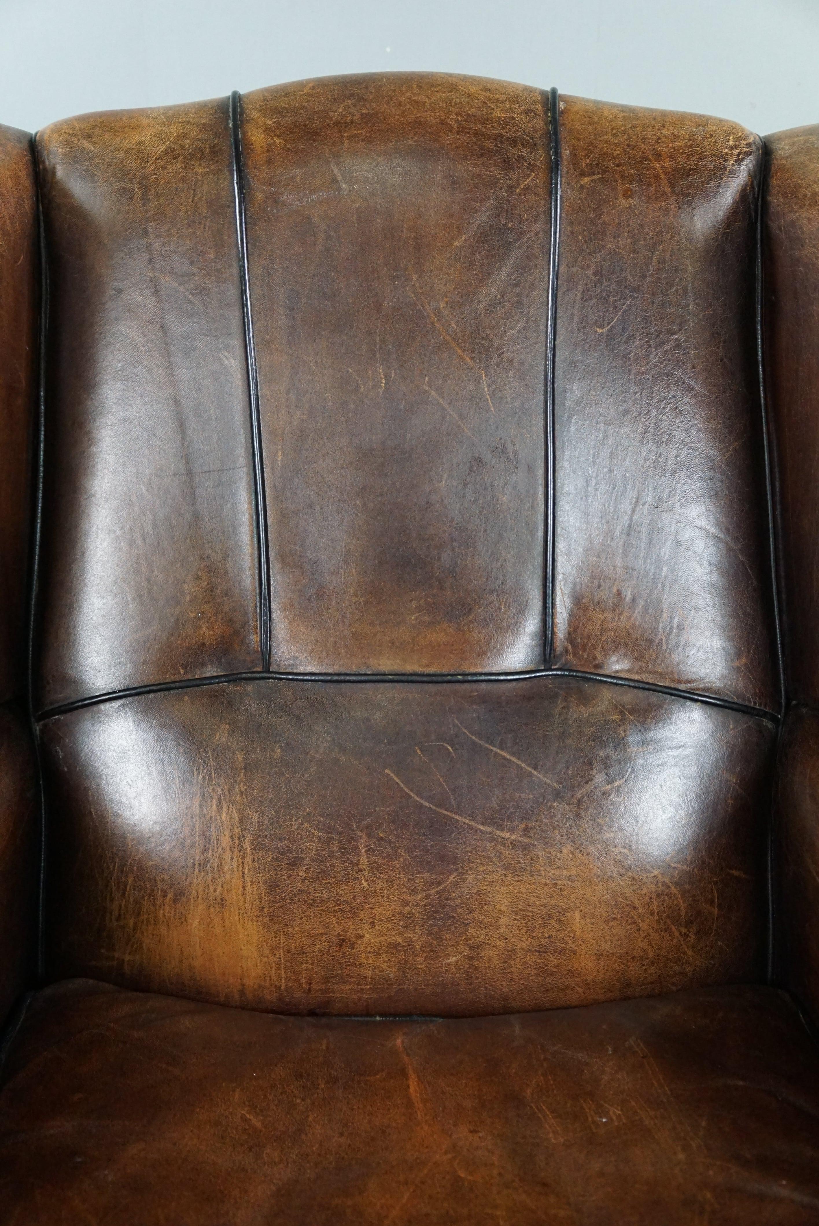 Charming sheepskin wingback chair with black piping and a beautiful patina For Sale 6
