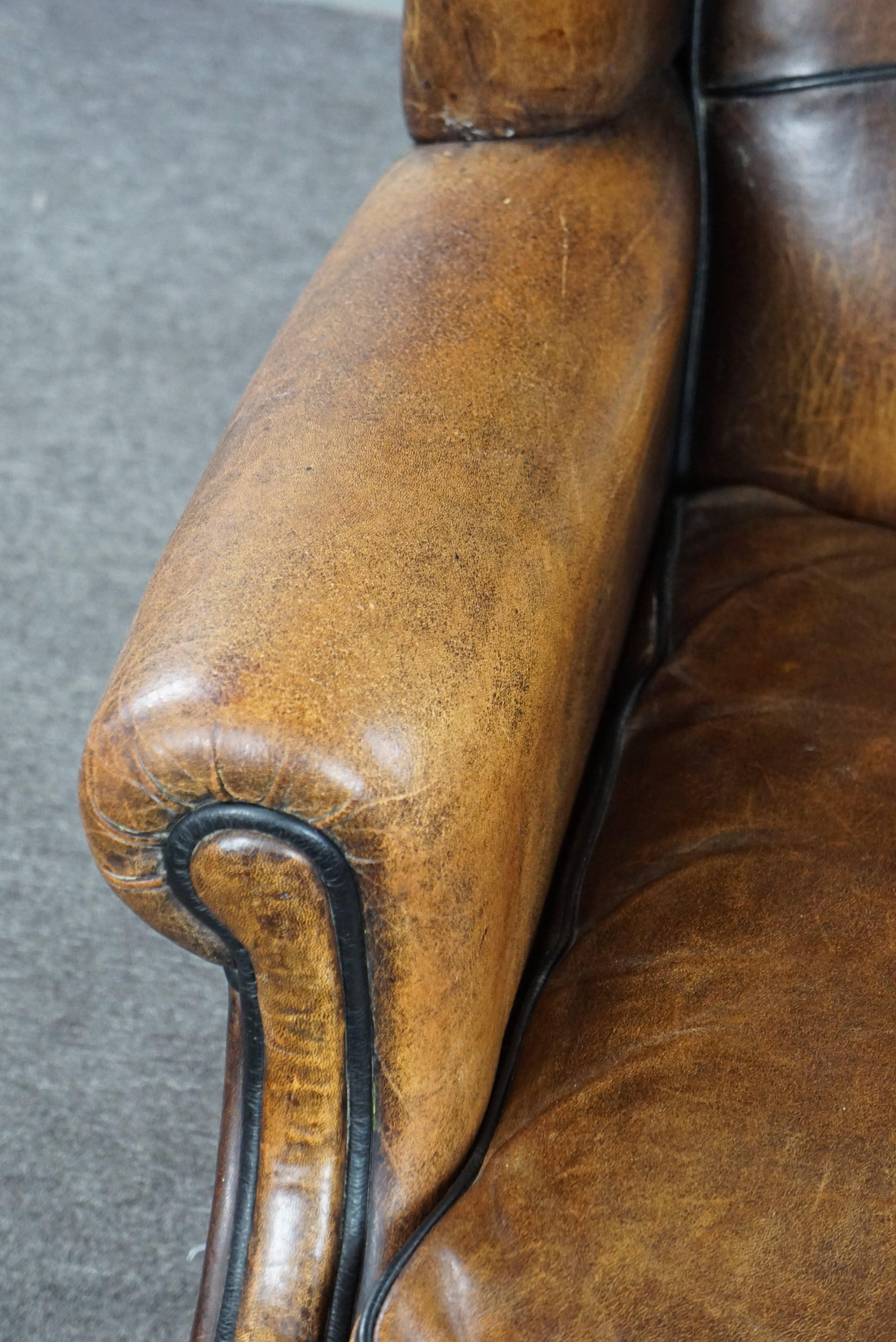 Charming sheepskin wingback chair with black piping and a beautiful patina For Sale 2