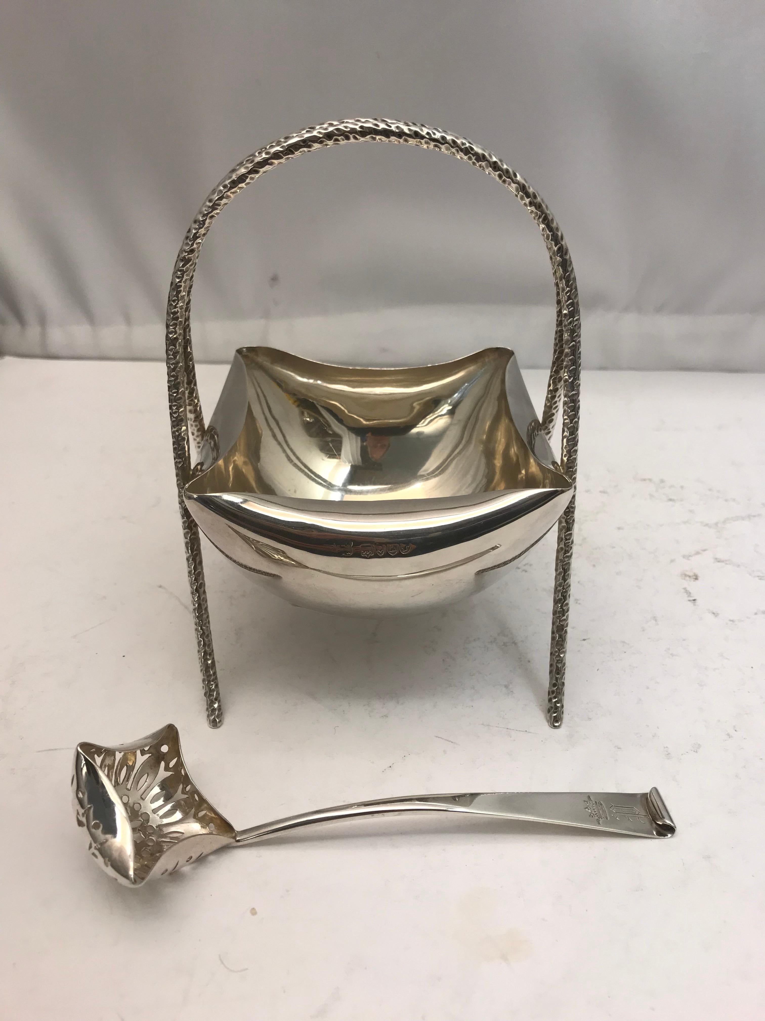 A charming silver Victorian bowl with a bent edge a handle adapted in the shape of an arch with a matching sifter spoon.

Marked on the top edge. Made by Huki & Heath London 1885.

This attractive bowl and spoon is in very good condition with no