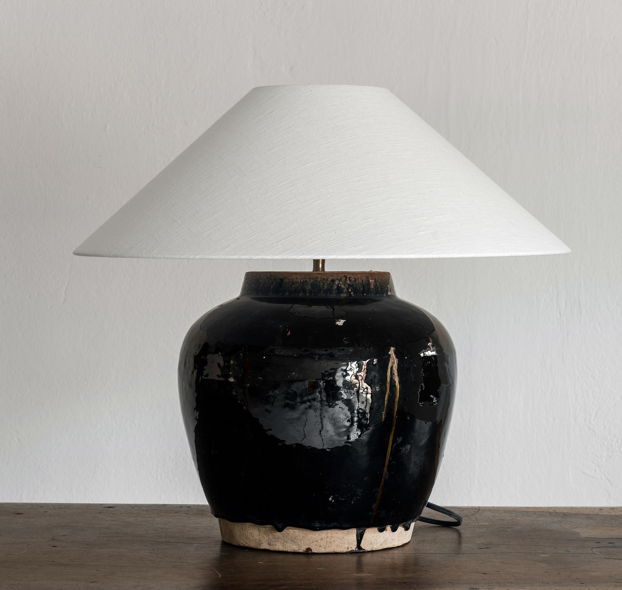 A beautiful unglazed Han dynasty style vase of very elegant and charming pot form.
Expectedly mounted as lamp. High quality mount with a brass adjustable pivot joint. Shade handmade in Belgium.
The vase is from Zhejiang, china, mount and shade are