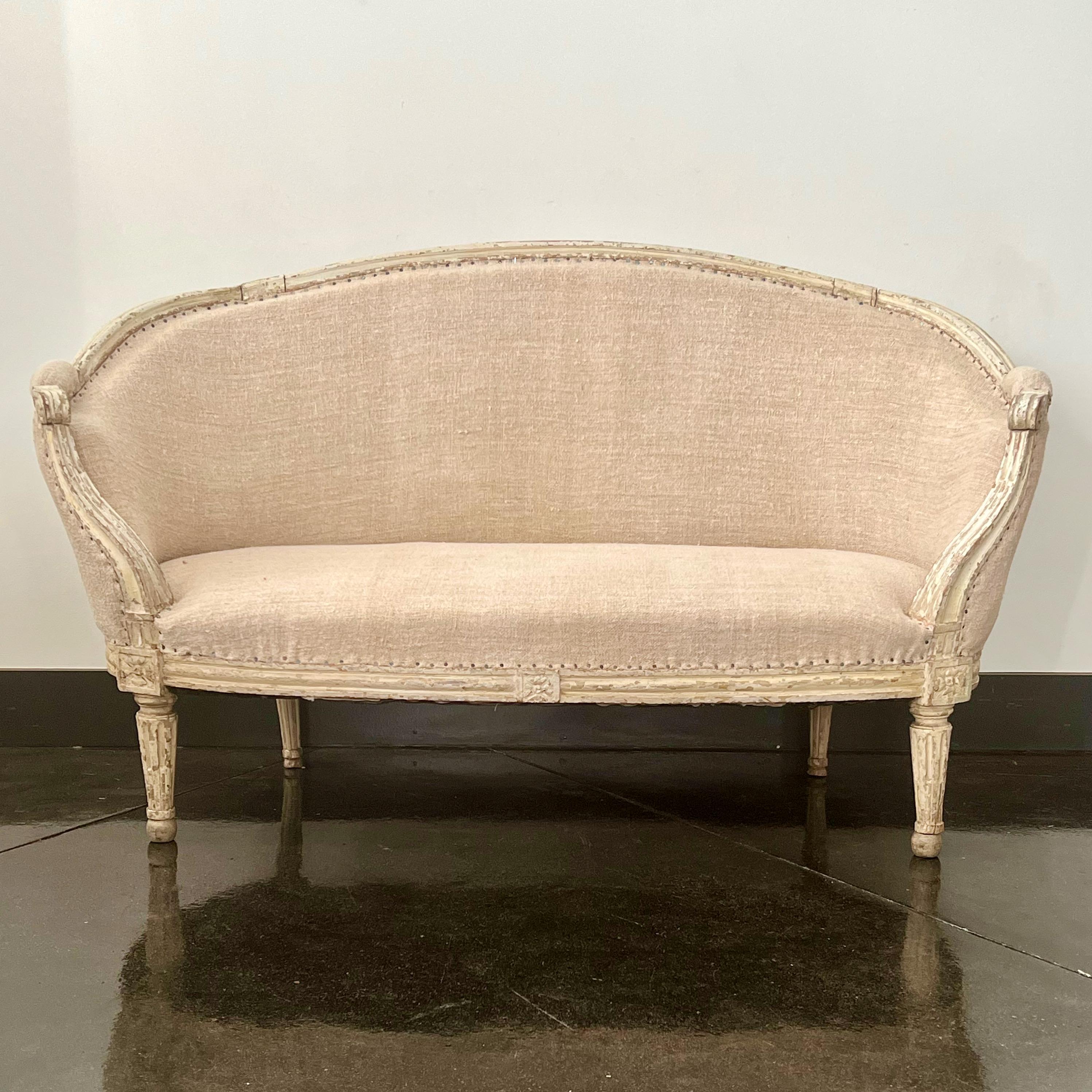 An elegant Louis XVI period settee with painted frame, and tapered fluted legs. re-upholstered in antique linens. 
France circa 1760.