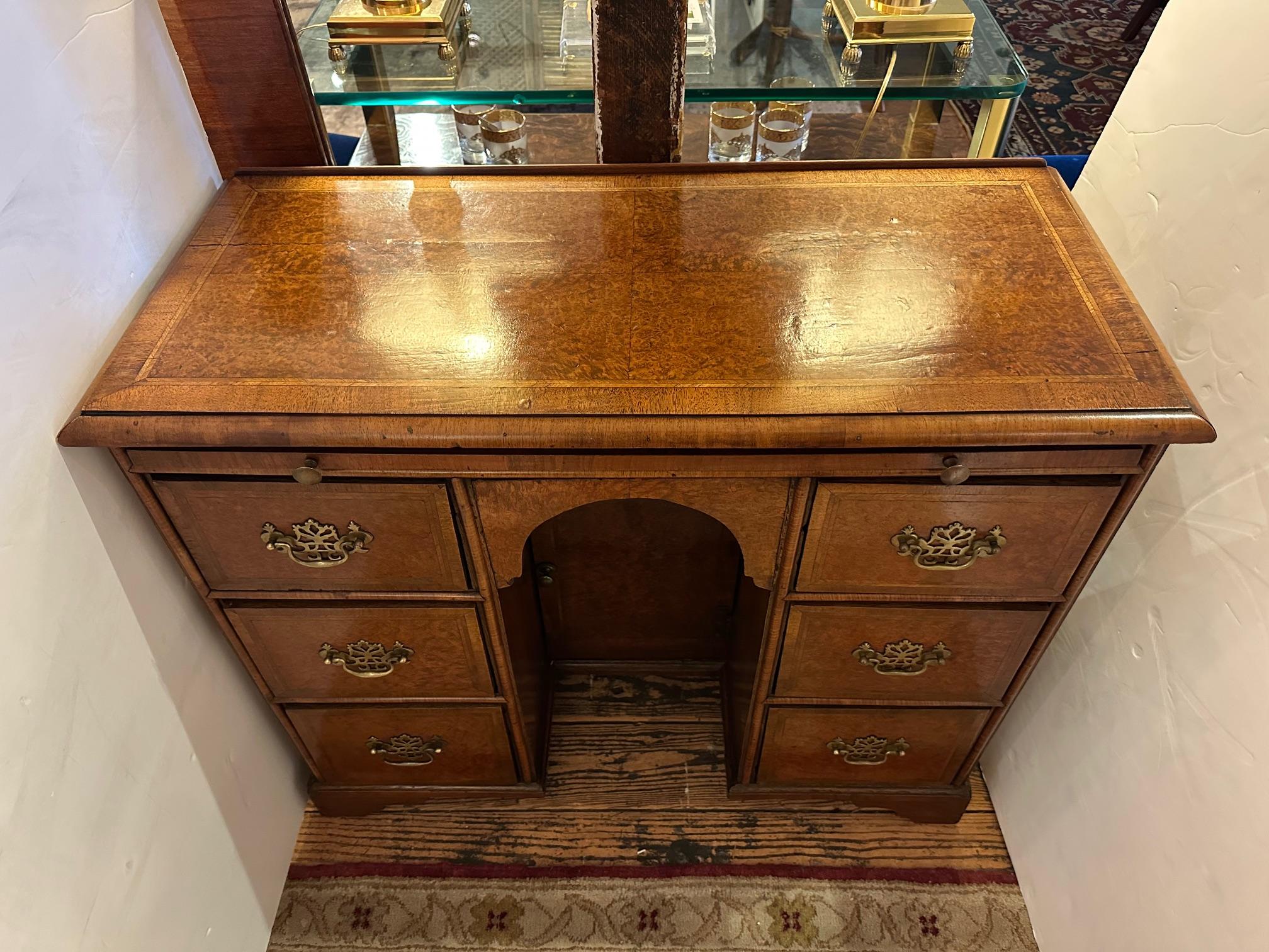 Charming antique knee hole desk having beautiful wood grain and lots of drawers and cubbies.  There’s a hidden pull out slide too.
Original brass hardware.
Opening 11 w 27.5 h 7.75 d


Aline