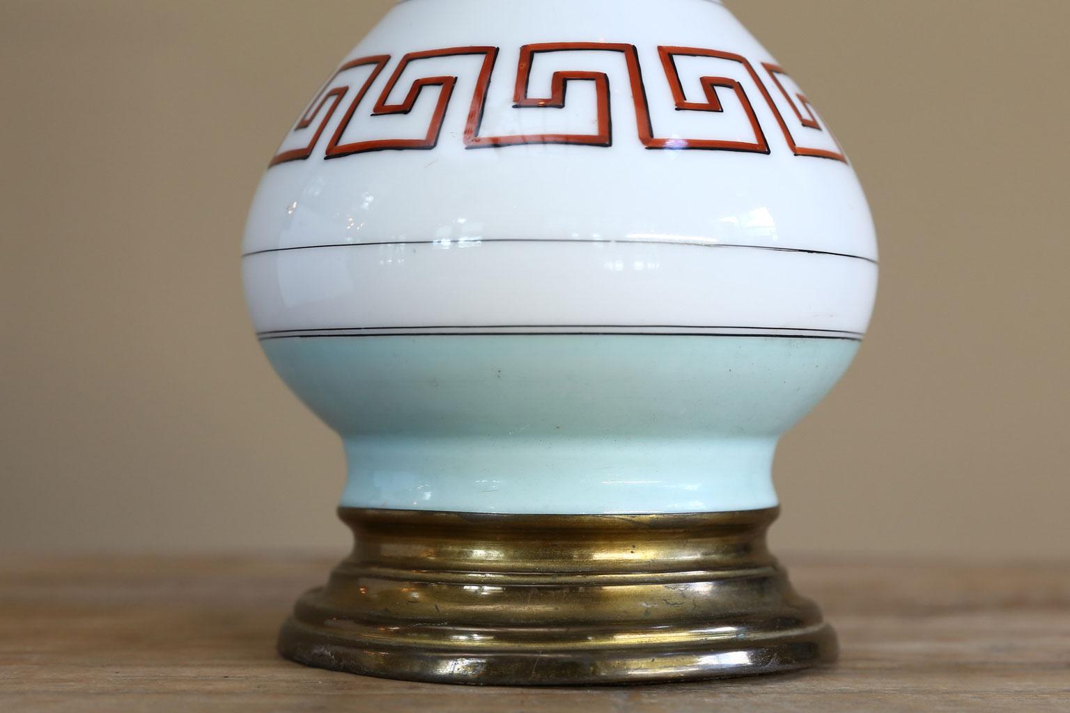This vintage American table lamp is hand painted porcelain. The colors or beautiful and Classic. The lamp has been restored and newly re-wired. The colors are robin's egg blue with black, white and terracotta.