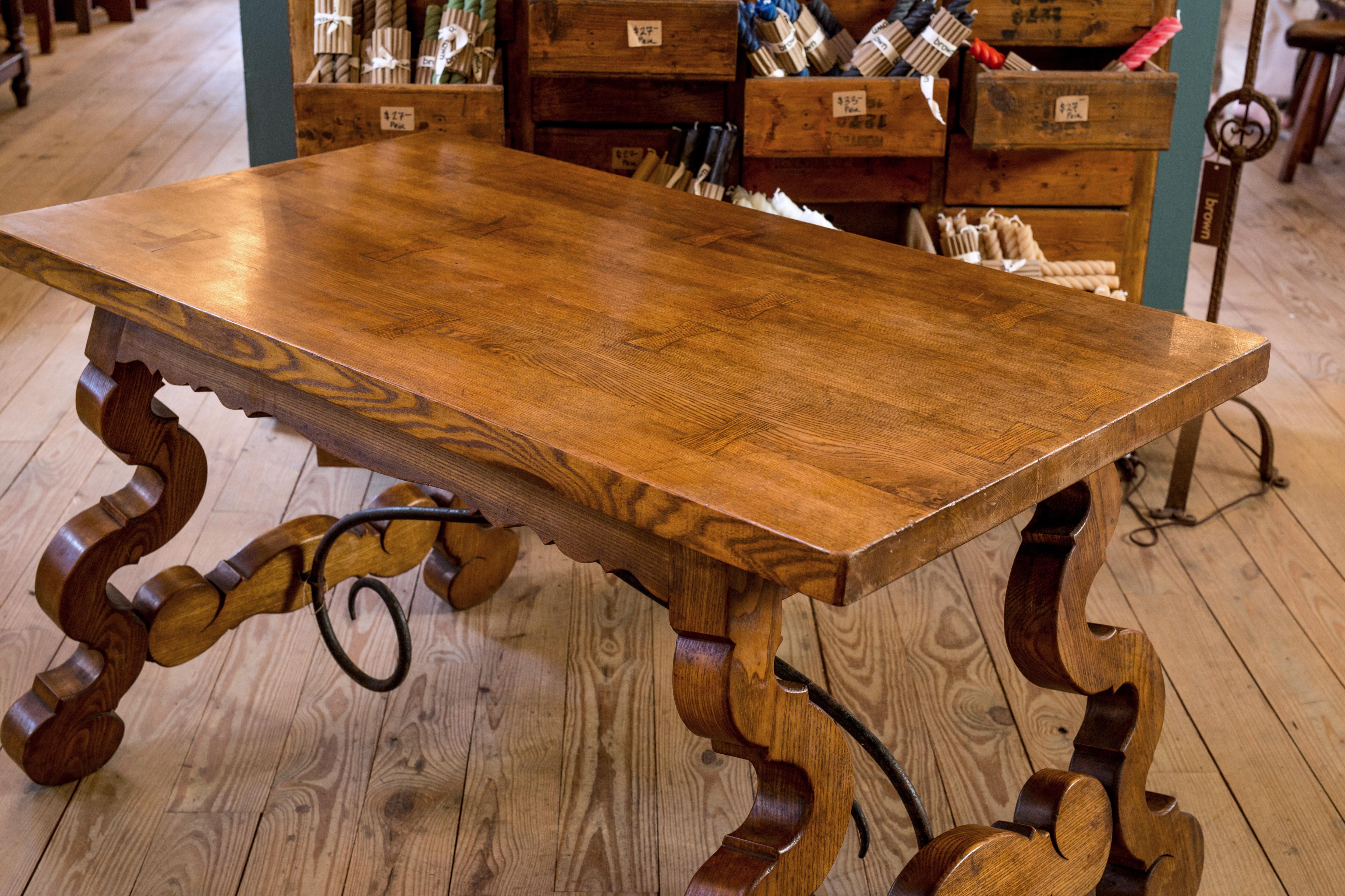 This table is made of massive oak and forged iron stretchers.

It has unusual and interesting dovetails in the top of the table.

It make a nice small dining table or a wonderful desk or console.