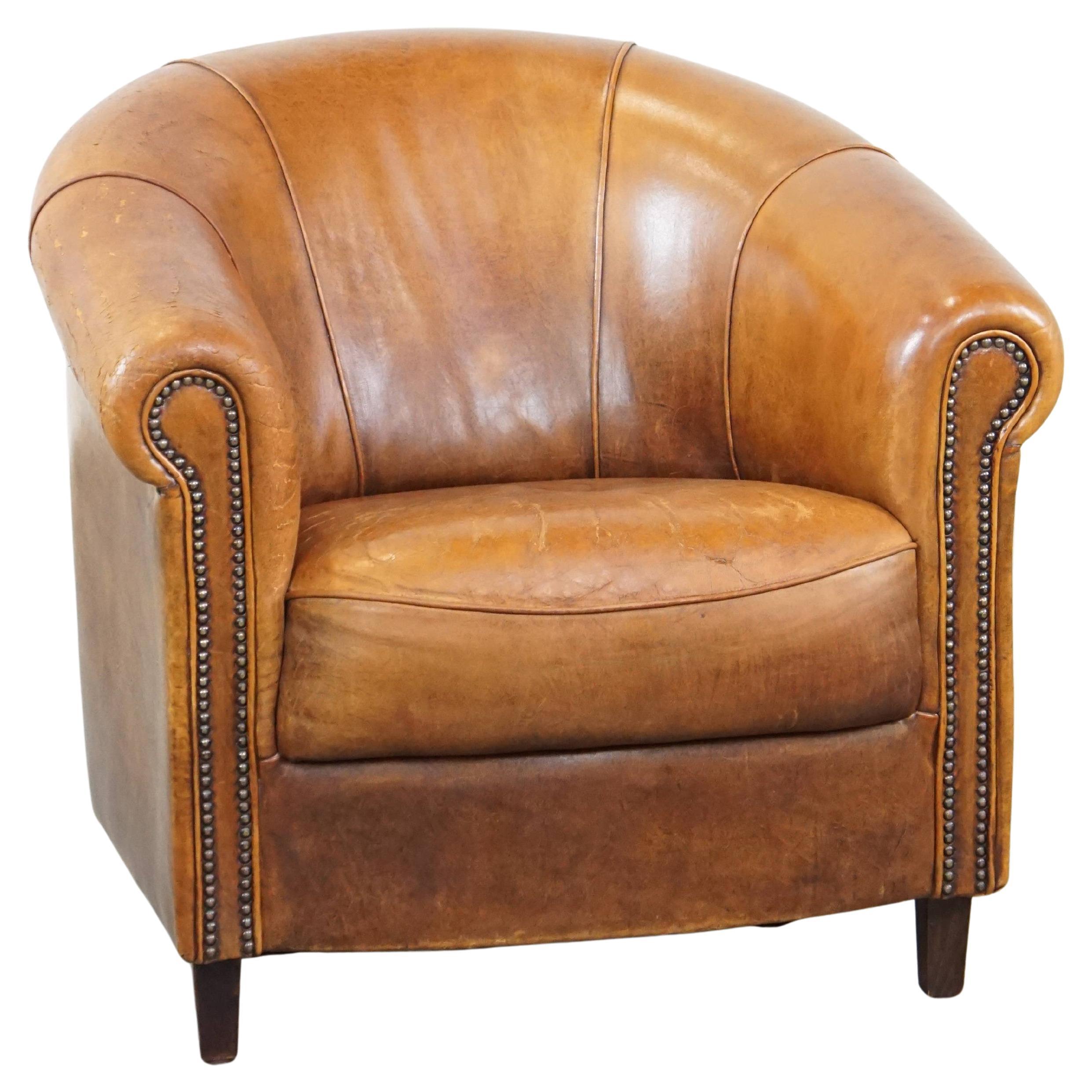 Charming, sturdy and comfortable cognac-colored sheepskin leather club armchair