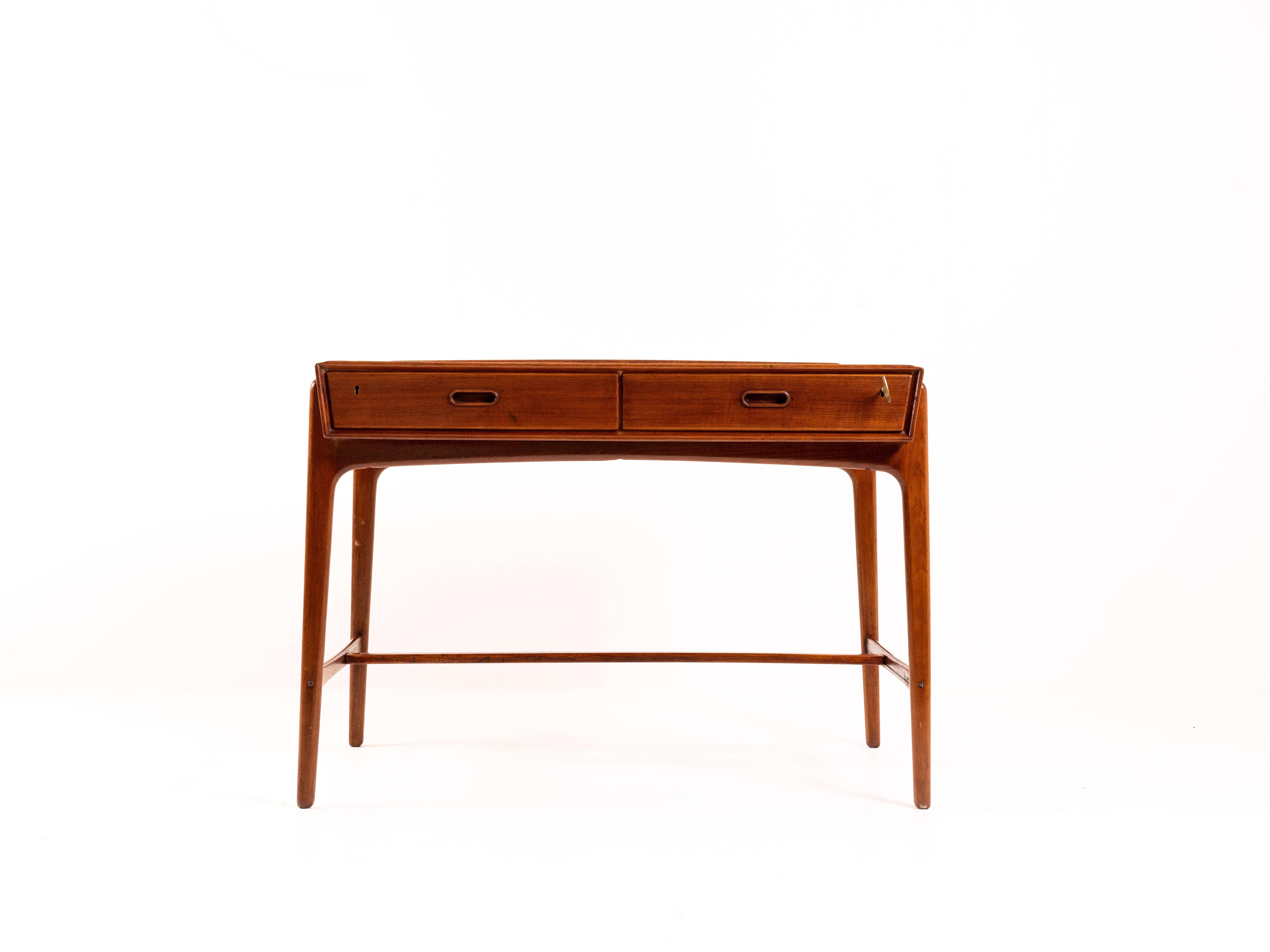 Charming Svend Aage Madsen desk in teak from Denmark the 1950s. This desk is produced by Sigurd Hansen. The design is remarkable and a true example of Danish Mid-Century Modern design and craftsmanship. It has two drawers and nice details; the