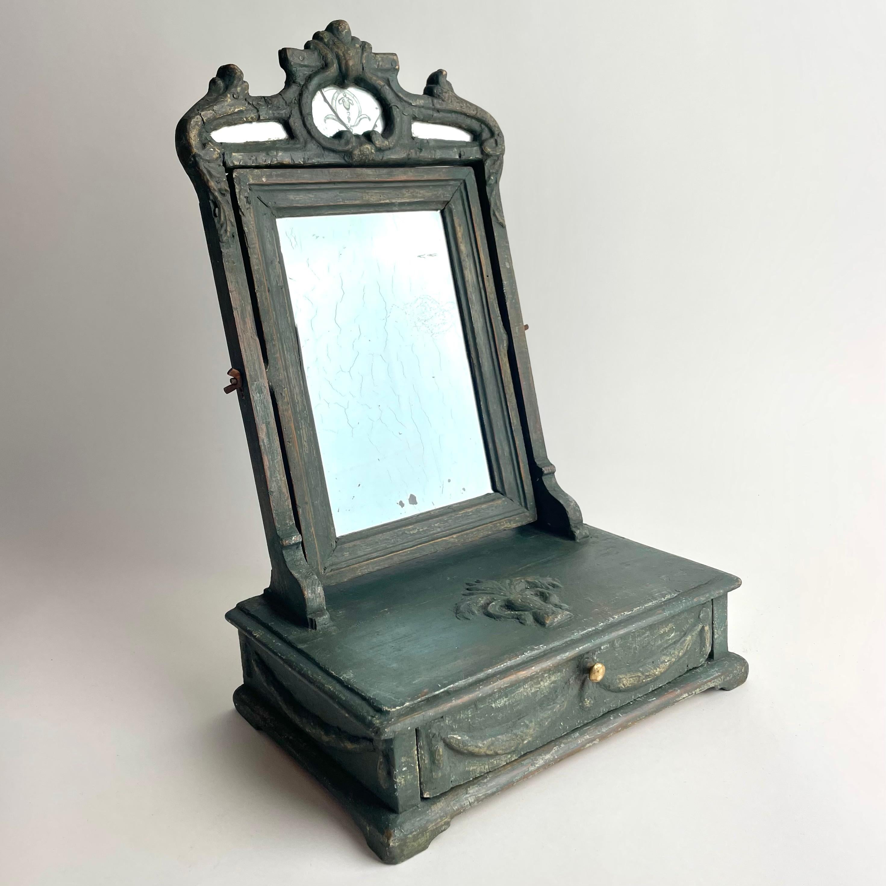 
Charming Swedish Gustavian Shaving Mirror, Transition Style, 1770s

A charming Gustavian shaving mirror from Sweden, dating to the 1770s, retaining parts of its original painted surface, later partially refreshed in the same beautiful tone. The
