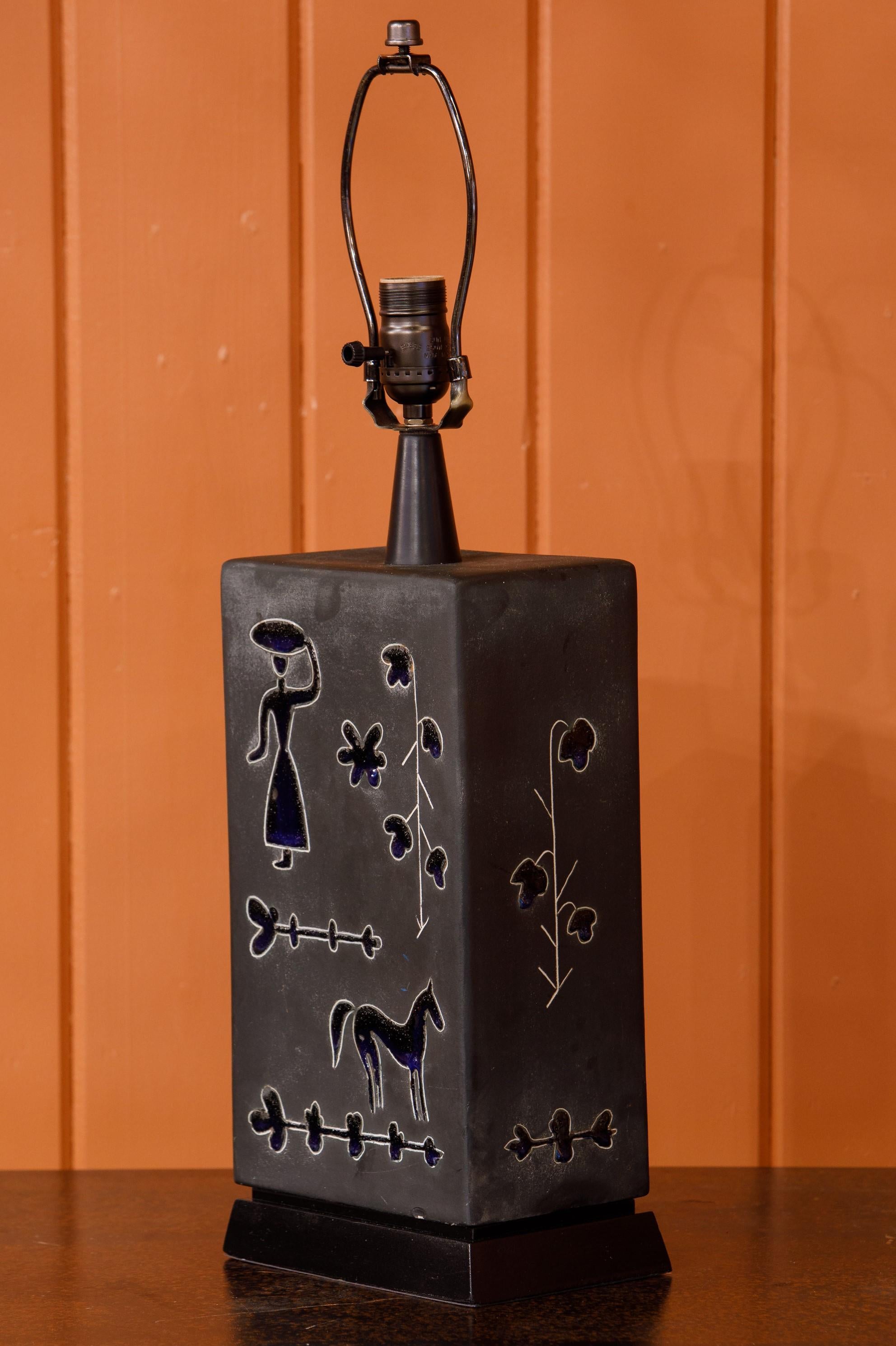 Charming hand-thrown Swedish pottery lamp with interesting folky woman and horse motif. Circa 1950s. Re-wired for USA with Edison socket. Classic Scandinavian Modern Object.