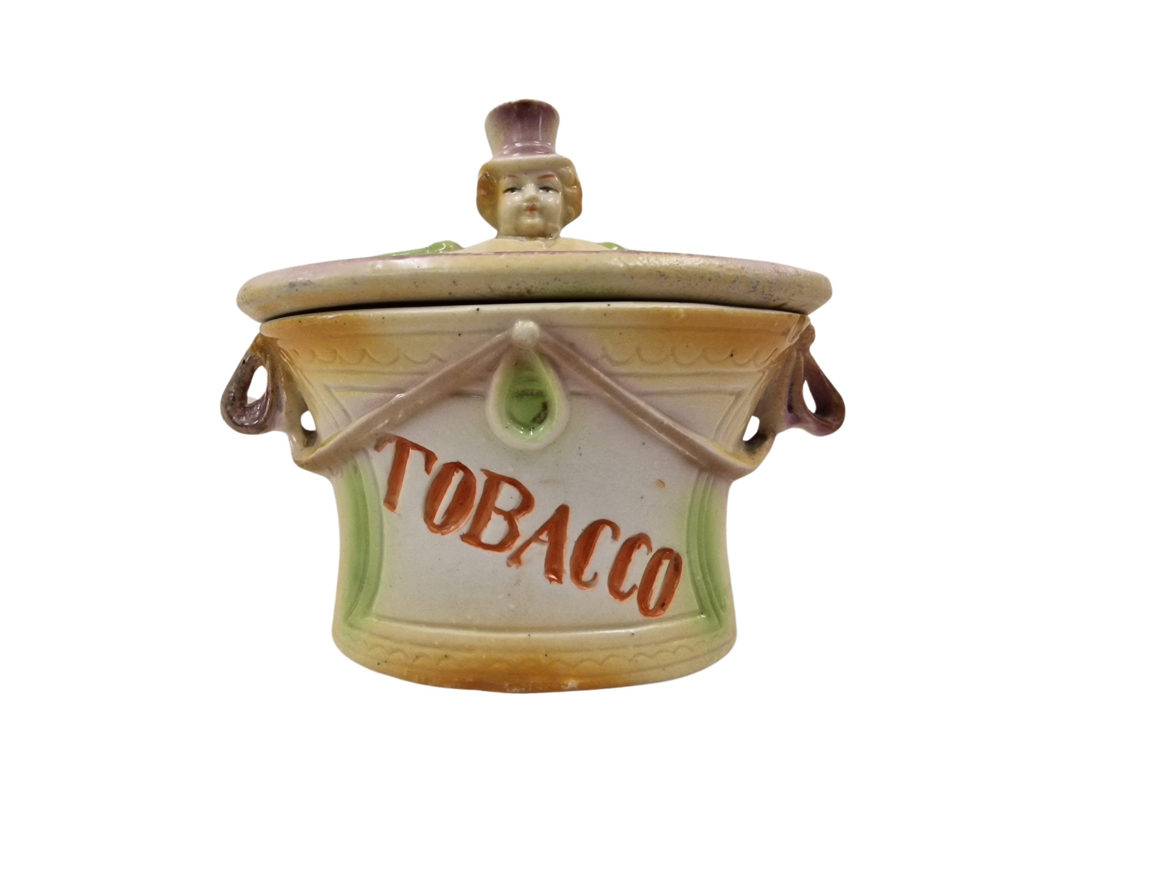 Extraordinary, charming tobacco box, made of bisque porcelain, around 1900, an original Art Nouveau piece, not labled but most probably made in England. 

The tobacco box is oval in shape and has a lid - the handle of which is in the shape of a
