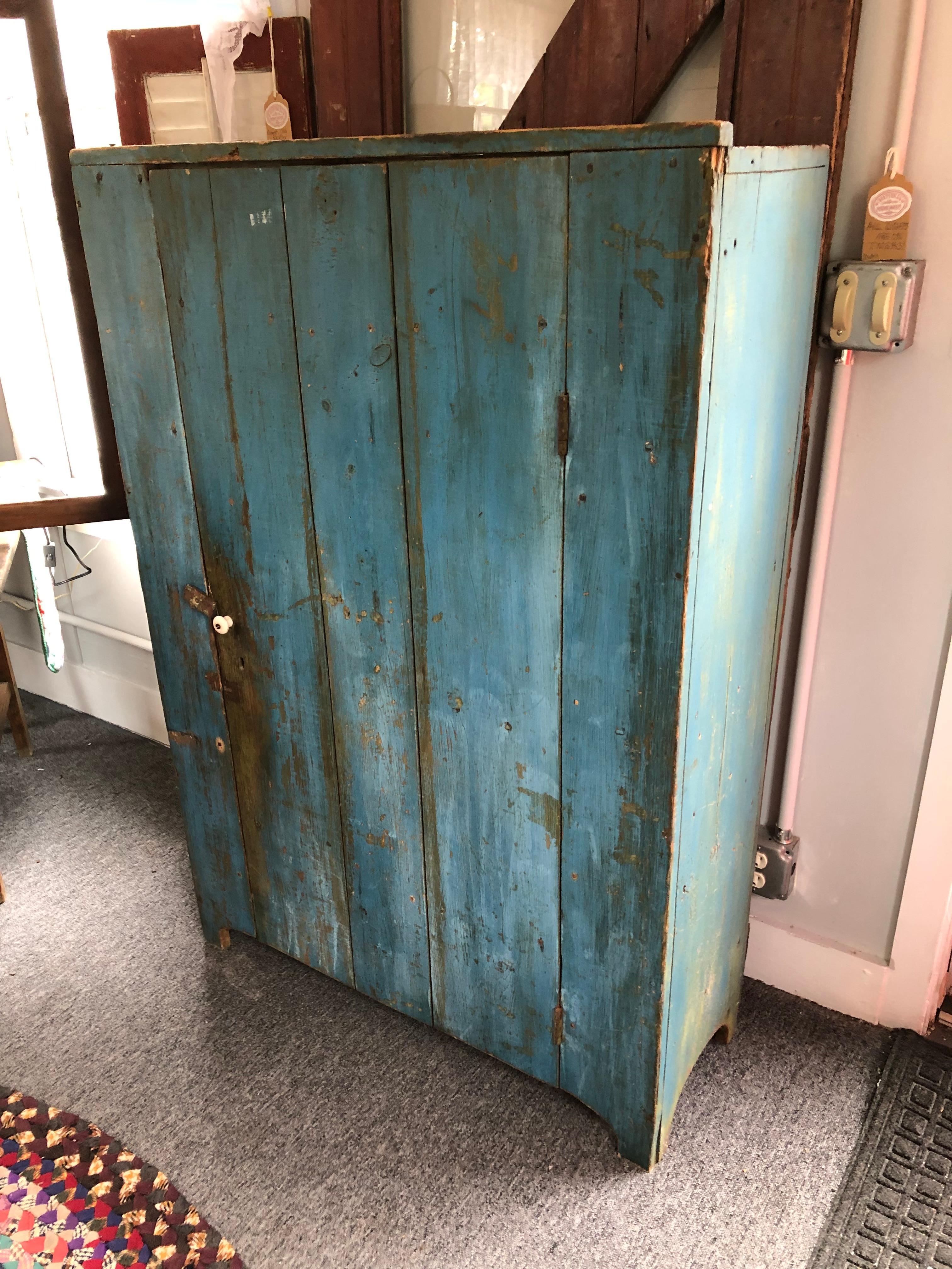 Super striking and charming New Hampshire country Primitive cupboard having reclaimed wood farm house style door and interior shelves for storage. The color is a marvelous weathered turquoise.
Shelves are 11.25 deep with 9