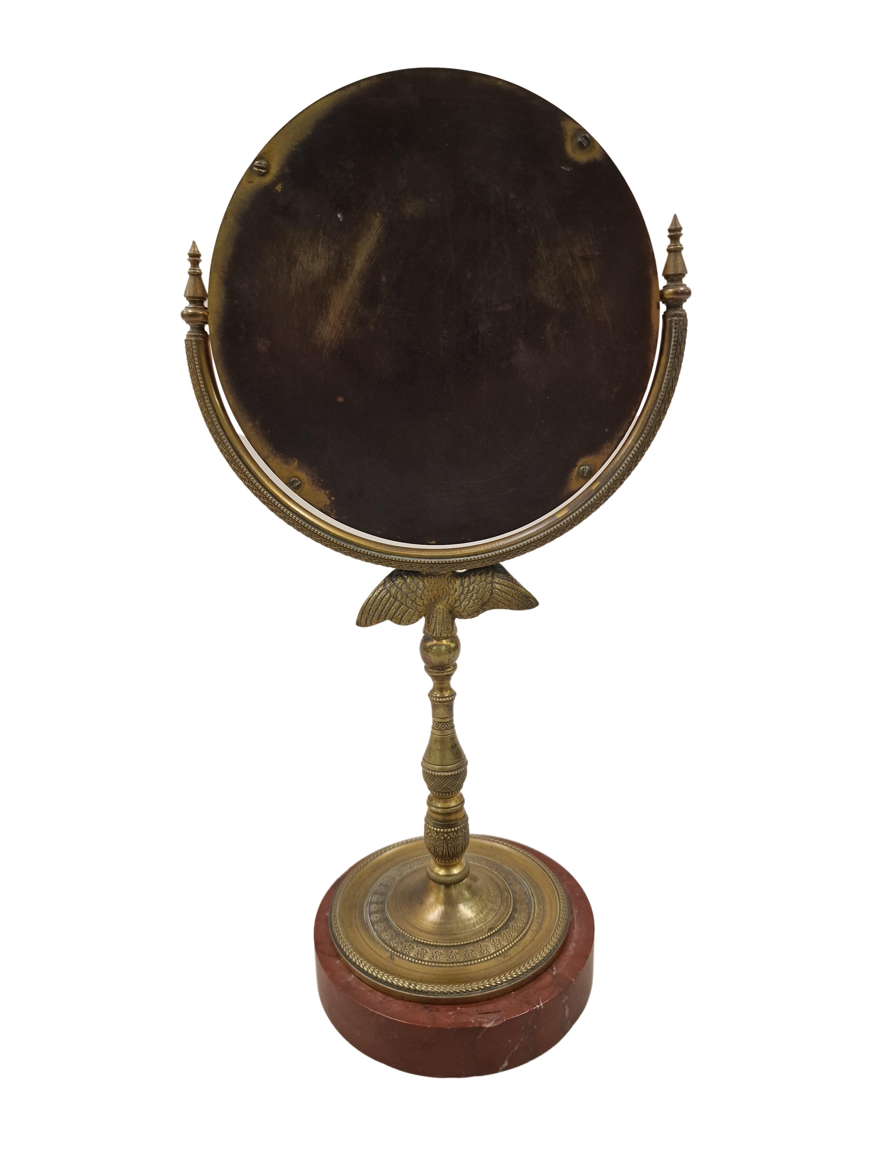 Charming table mirror, a high quality work, made around the 1820s in France. 

The stand is out of bronze with a red marble base. The bronze stand is very delicately worked, with many beautiful details, including flower decoration, acanthus tendrils