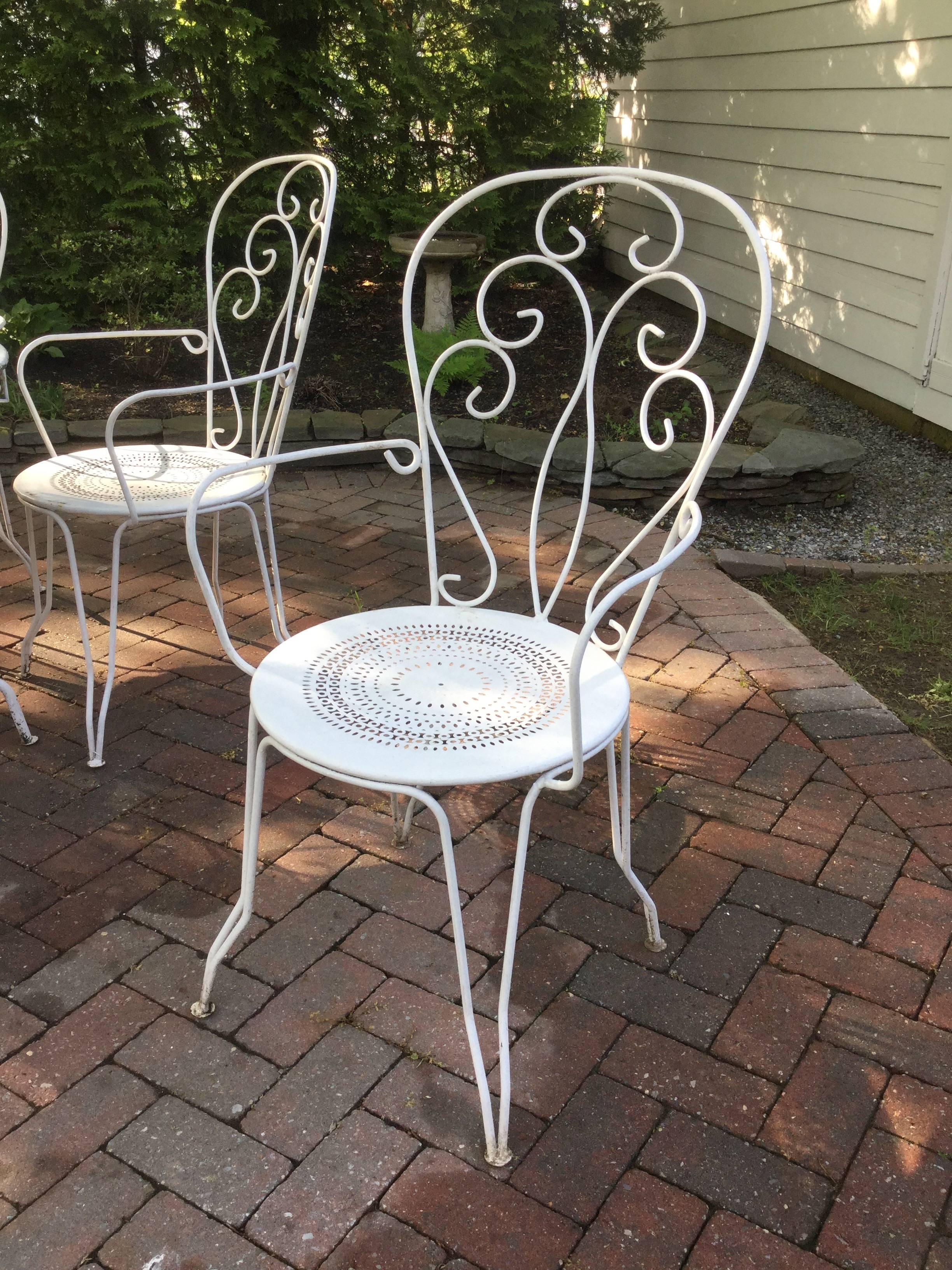 Classic vintage French cafe set having a round iron table and set of 6 matching chairs. Chairs are 39