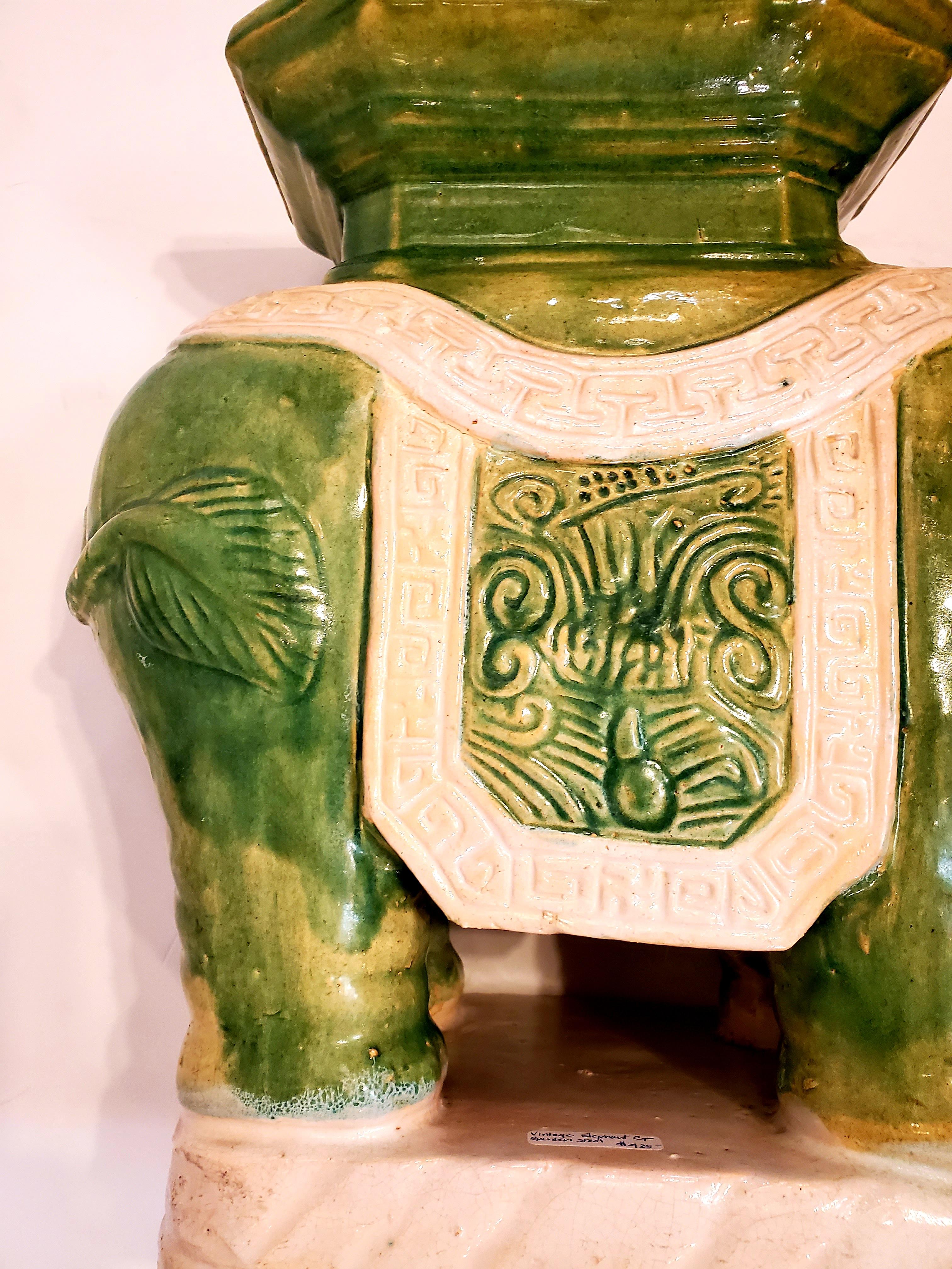 Stylish indoor outdoor ceramic garden seat in the shape of an elephant having octagonal table surface and versatile green and white color palette. Makes a wonderful drinks table.