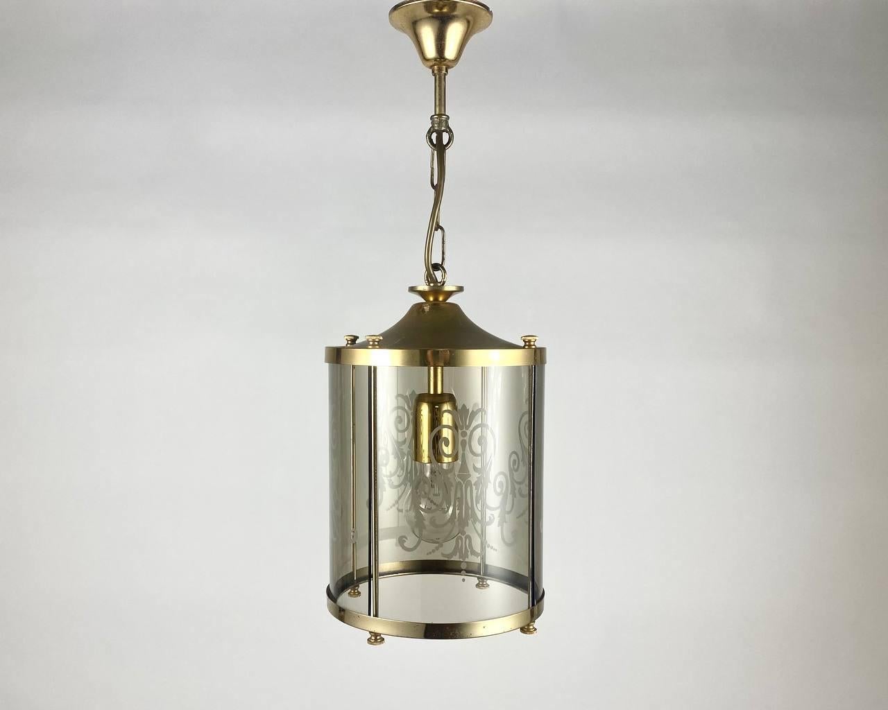 Beautiful cylindrical lantern made of smoked glass and metal with engraving. 

Vintage Lantern made of glass and metal combines vintage charm and modern design creativity! Carefully selected materials, amazing handmade details and the reverent