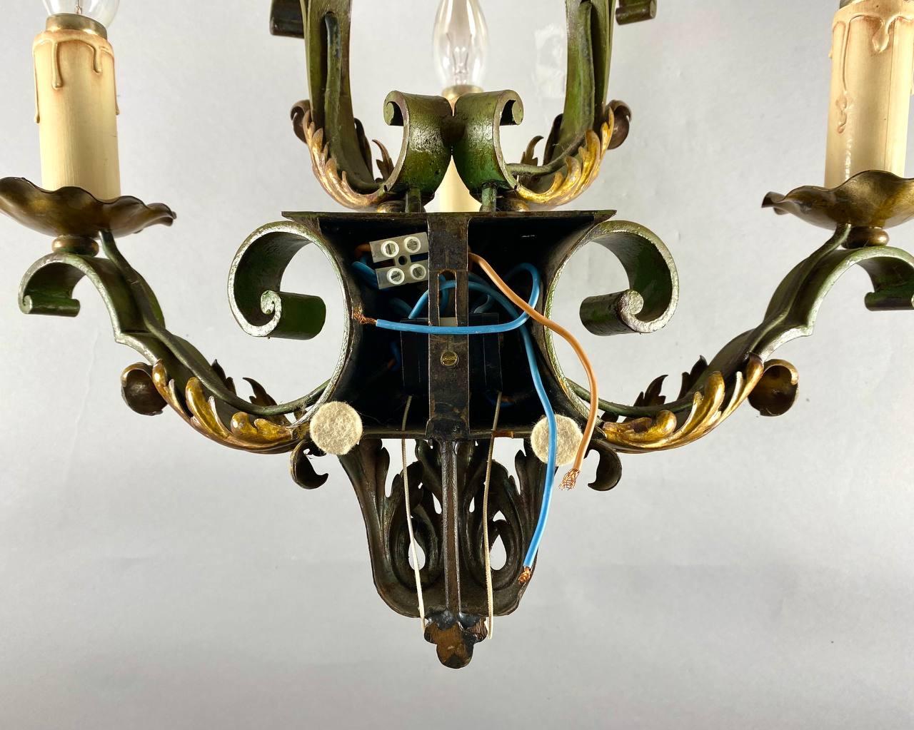 Wonderful an old five-light metal wall sconce with gold acanthus leaves and scrolles in a beautiful original shape. 

 The horns of the sconce arr crowned by metal cups and a stand emanating from it with a cartridges closed by a glass in the form