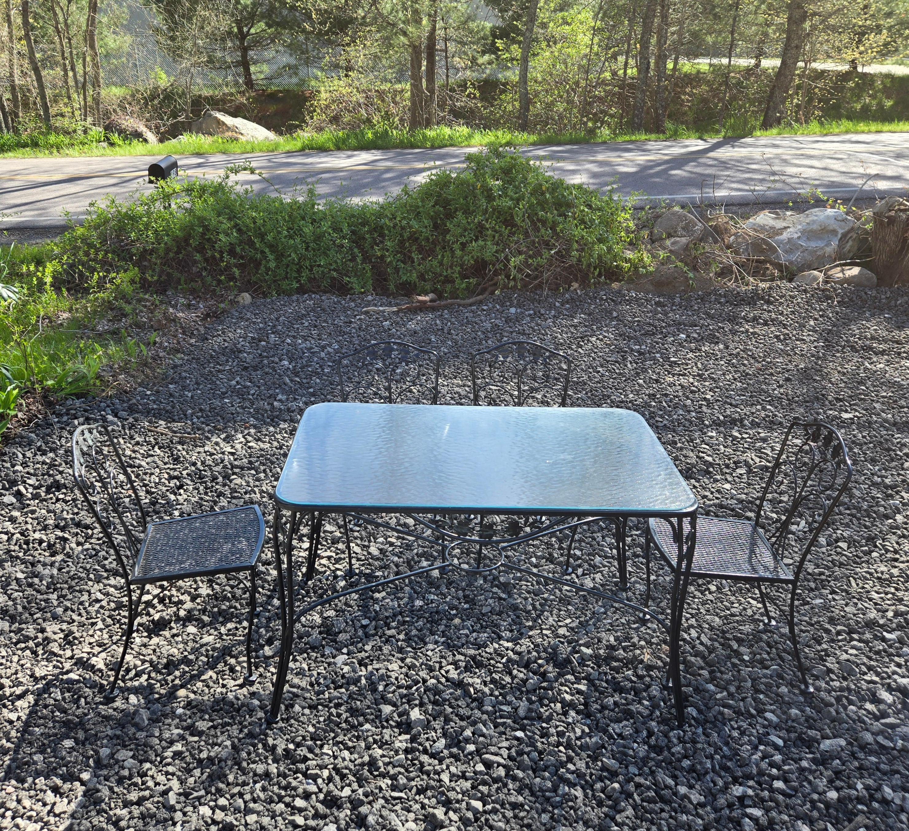 This Meadowcraft wrought iron dining set is perfect for any outdoor space. With a table and 4 chairs, there is ample space for you and your guests to dine comfortably. The rectangle table shape with flower motif adds elegance and sophistication to