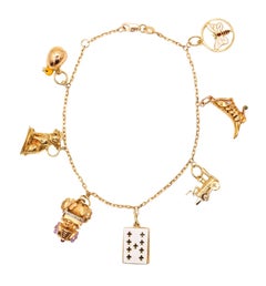 BRACELET DE CHARMES 1960 Bracelet de 7 charms en or jaune 18Kt de style moderniste italien
