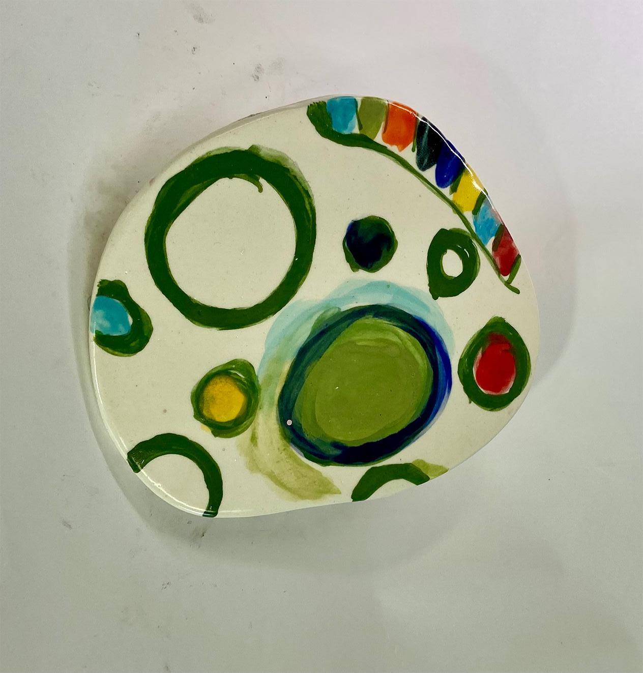 Untitled XXIII, by Charo Oquet
Glazed ceramic and enamel
Overall size: 27.5 H in x 24.5 W in.
Set of 14 Glazed Ceramic Discs
Individual size: 
1. 3.5” x 3.5” x 0.25