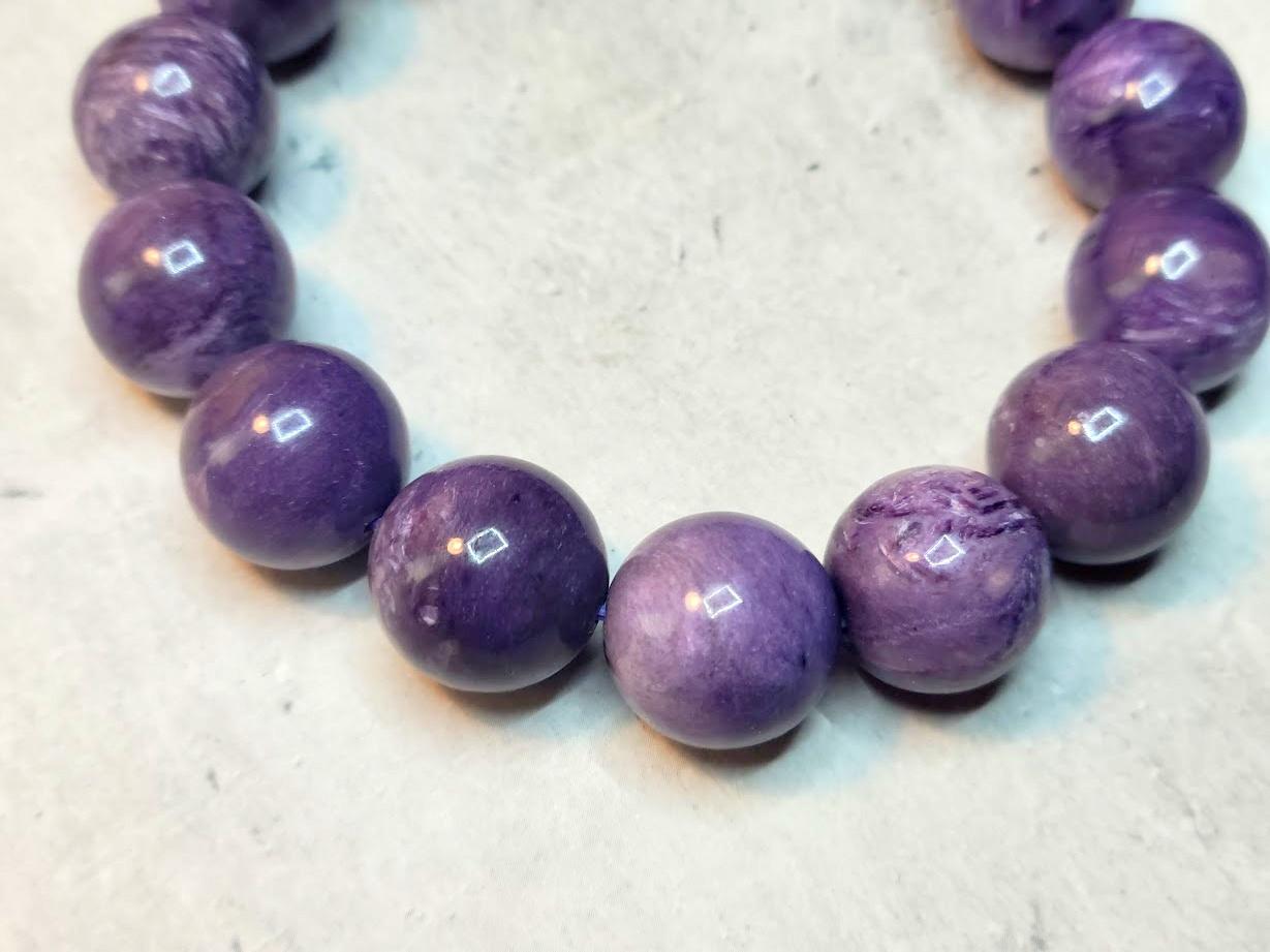 Fabulous Charoite bracelet!
The necklace is 9 inches long (22.8 cm) and weighs 67 grams (2.3 oz). The size of the smooth round beads is 14.5 mm.
The beads are not just purple; they are a unique shade of purple that can change its tone at different