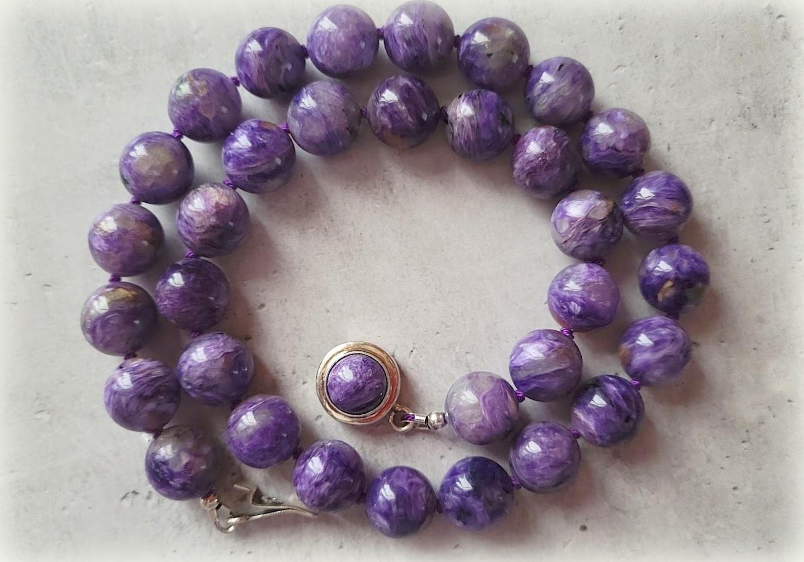The length of the necklace is 18.5 inches (47 cm). The size of the smooth round beads is 12mm.
The color of the beads is unusual, with a silk effect. Charoite color is non-uniform and can change its tone at different angles. Its color varies from