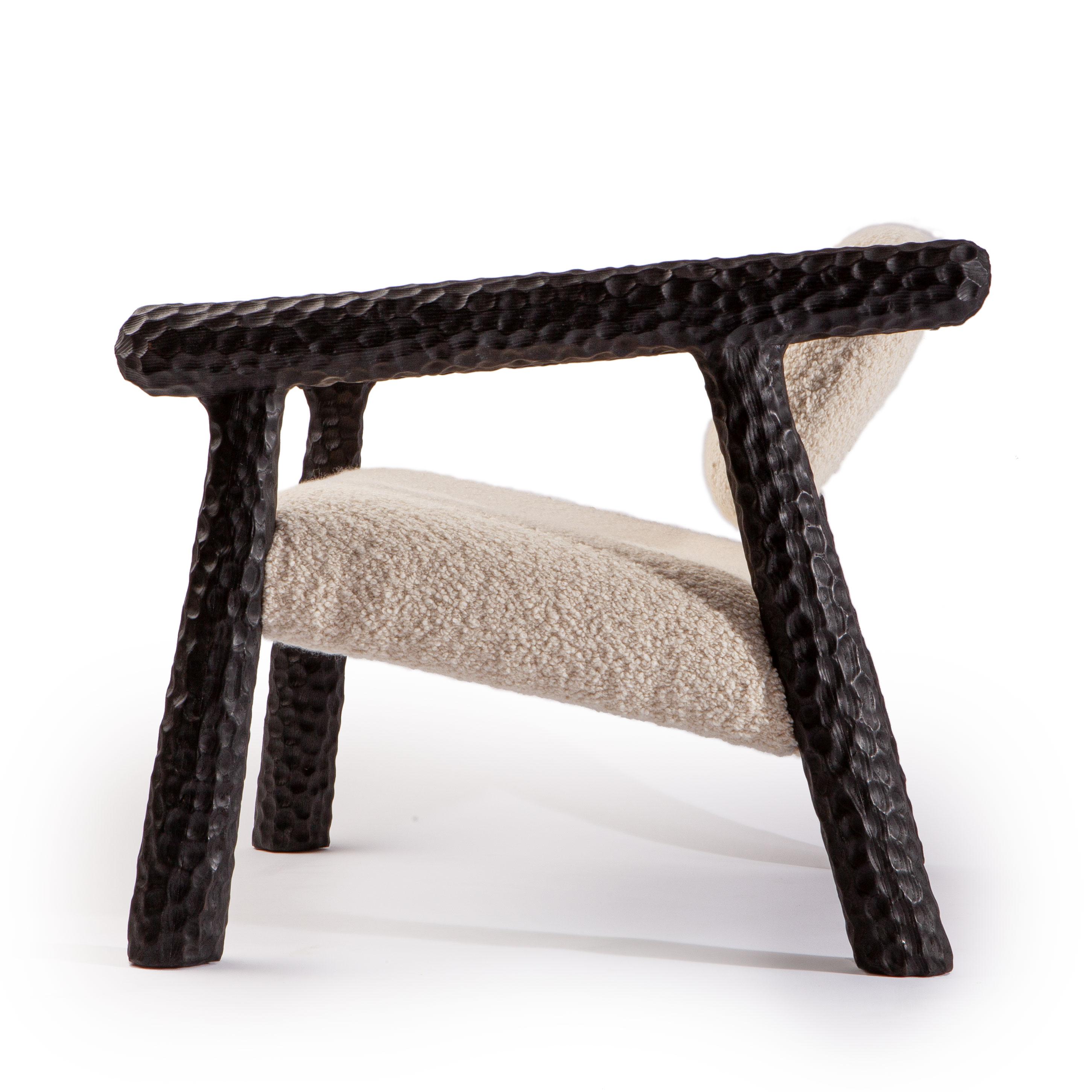 Carved Charred Chunky Chair with Bouclé fabric For Sale