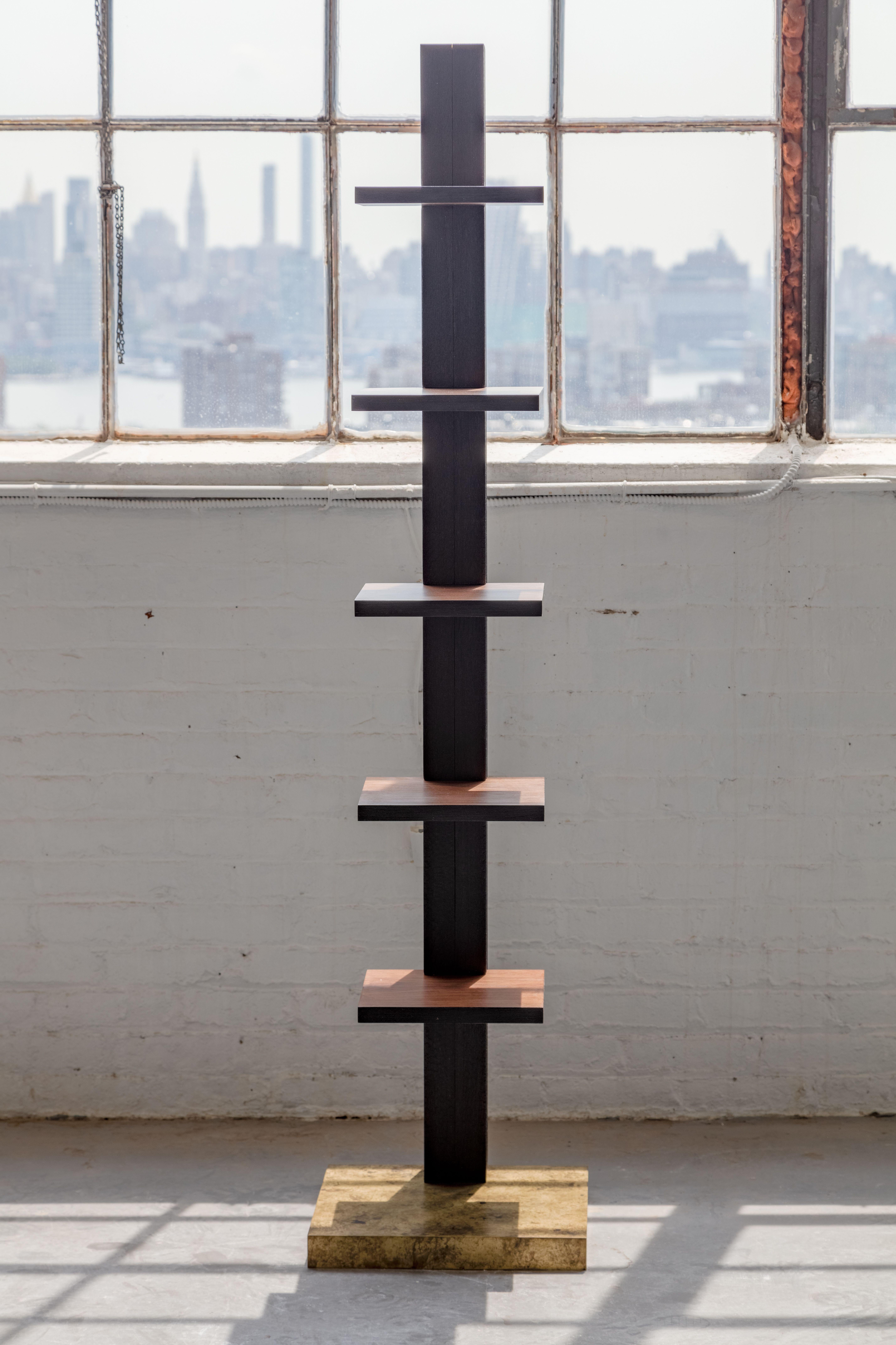 The Totem bookshelf explores a simple form with a mix of materials. Its back support is constructed from solid oak and charred black with a torch to create a scaling texture know as sho sugi ban. Each shelf is constructed from solid walnut with a