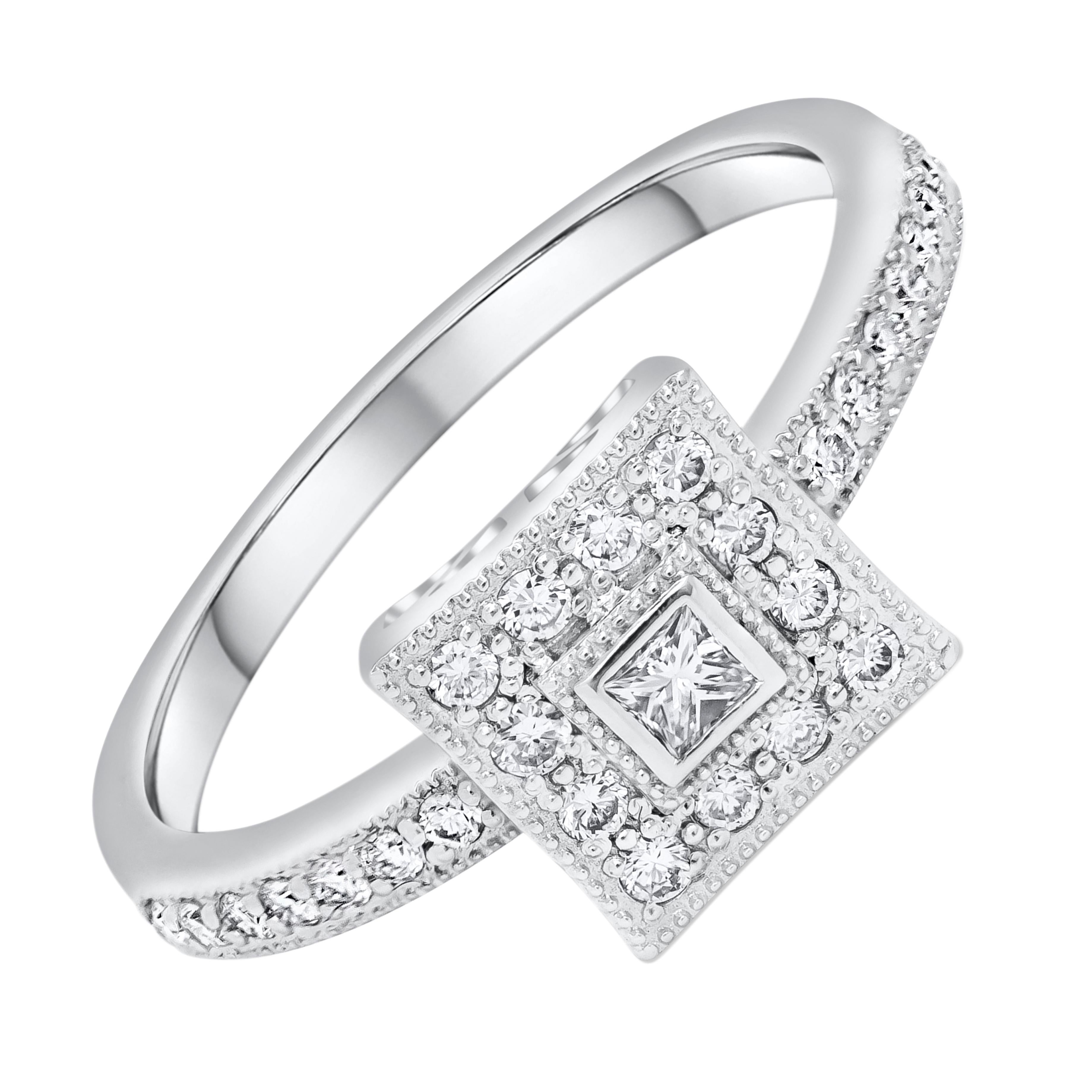 Features a 0.07 carats princess cut diamond bezel set in 18k white gold. Surrounding by single row of round brilliant diamonds, set in an accented 18k white gold shank. Accent diamonds weigh 0.30 carats total. Finished with milgrain edges for an