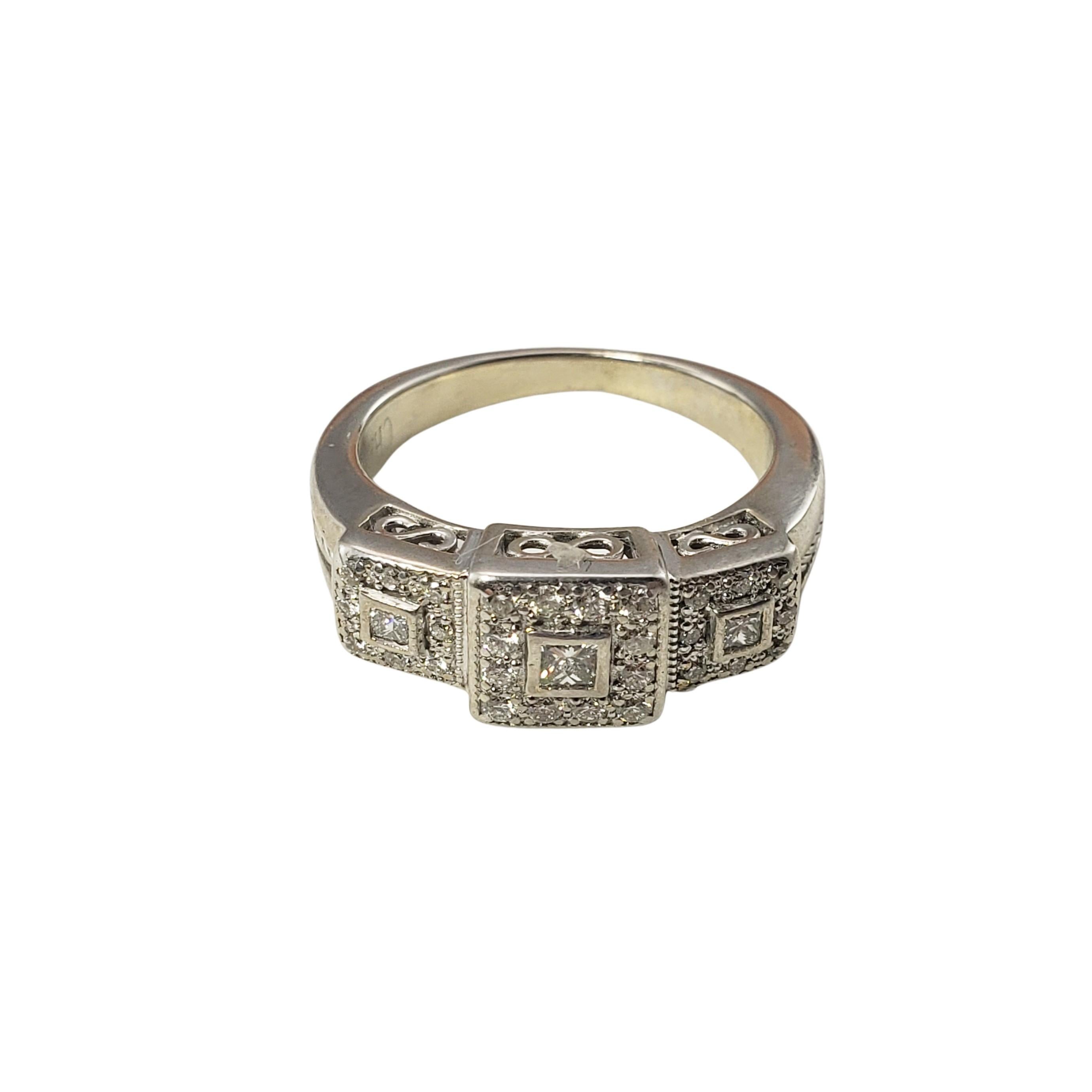 Charriol 18 Karat White Gold Diamond Ring Size 6.75-

This sparkling ring features 3 princess cut diamonds and 28 round brilliant cut diamonds set in beautifully detailed 18K white gold.
Width:  7 mm.  Shank:  2 mm.

Approximate total diamond