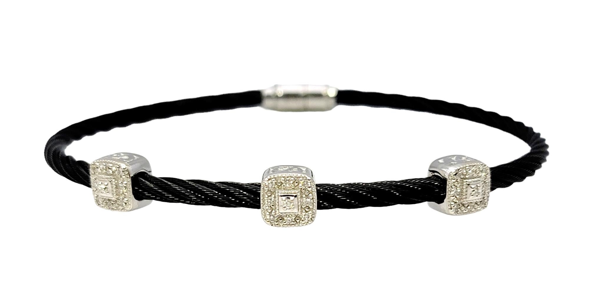 Simple yet elegant Charriol diamond station bracelet with a sturdy flexible black stainless steel cable cord. Three white gold square stations are adorned with sparkly white diamonds, offering a nice contrast to the dark cable bracelet. Would look