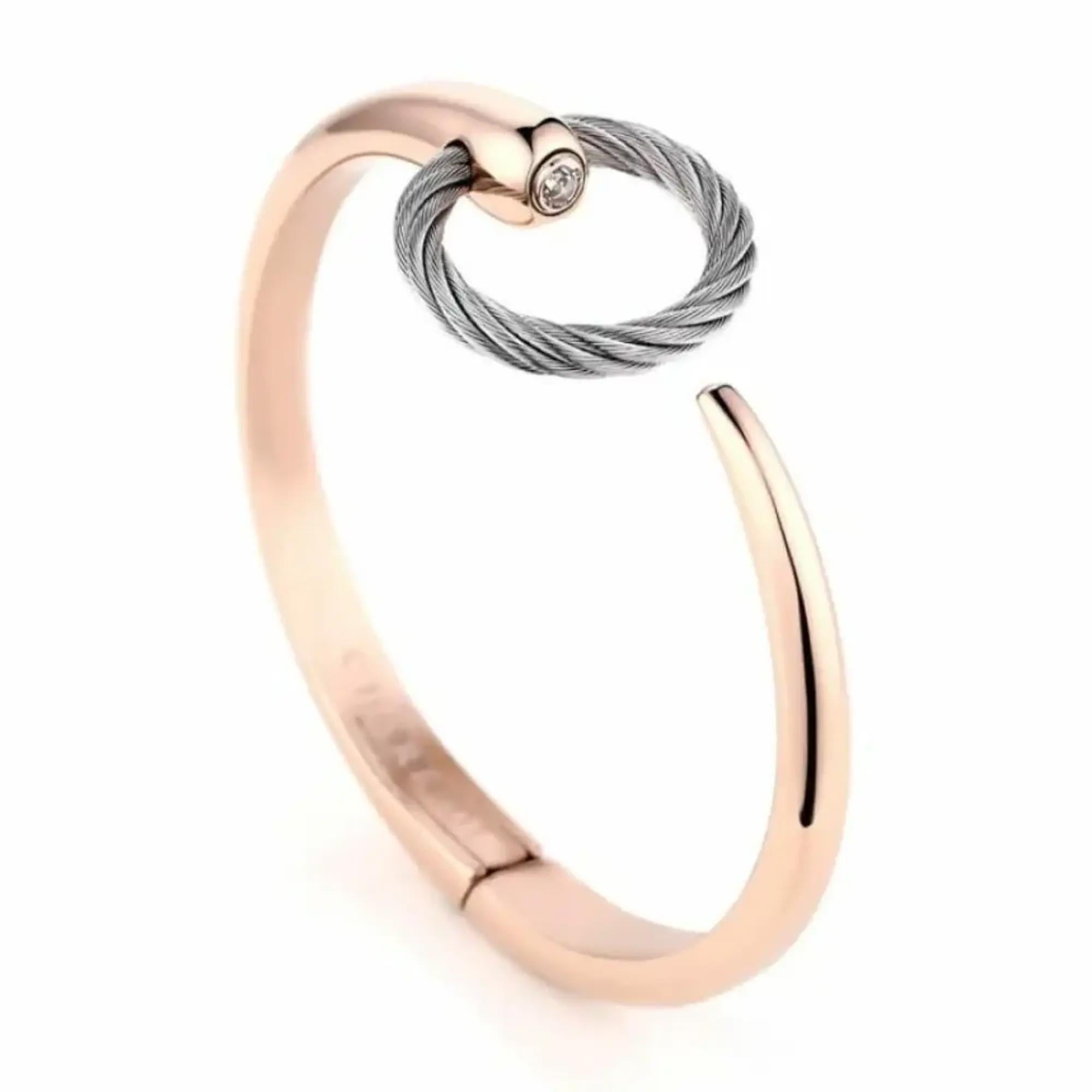 This gorgeous Charriol Infinity Zen open cuff bangle bracelet is a perfect addition to your everyday look. Super stackable and easy to wear, it features a stainless steel hinged bangle with rose gold PVD plating featuring a steel cable circular