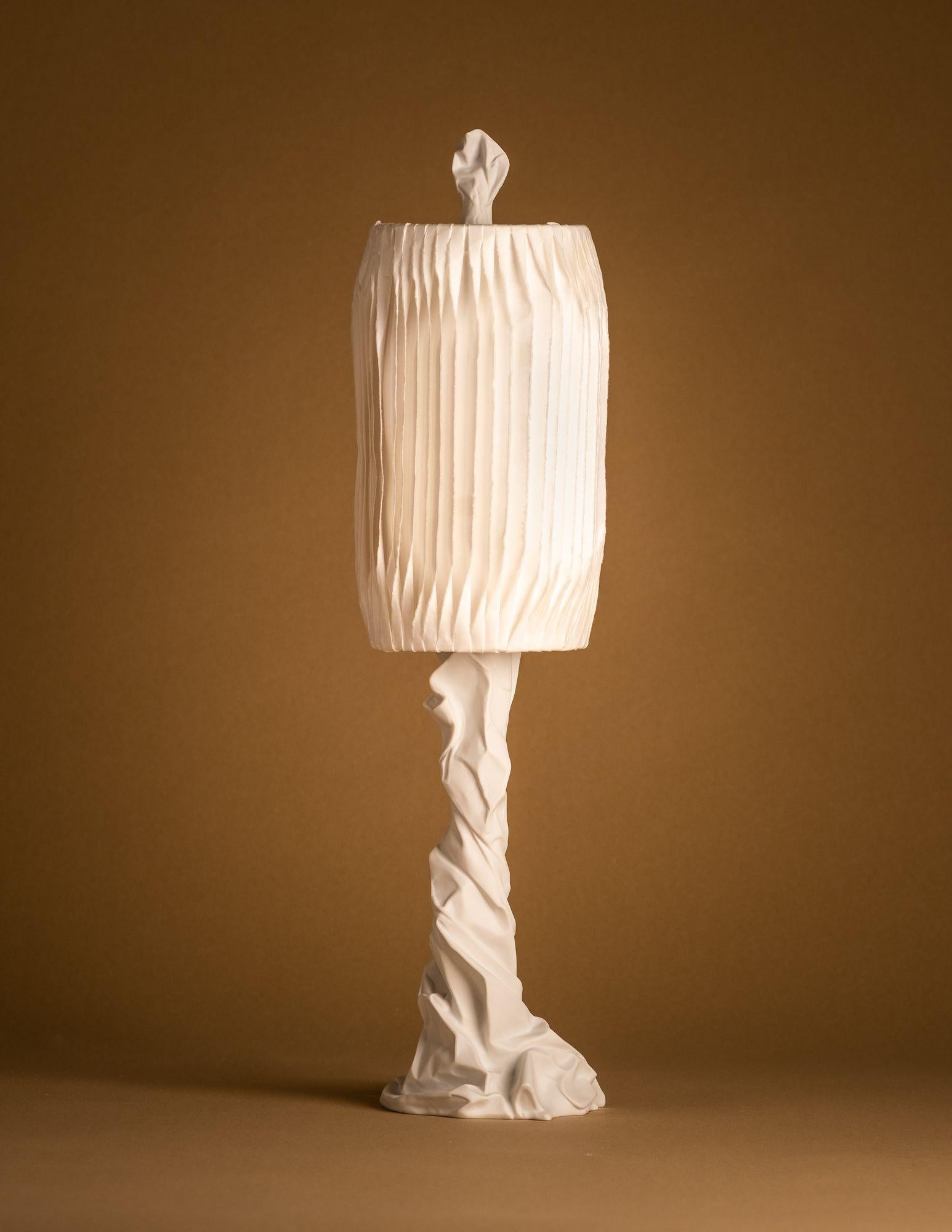 Charta Alba mini table lamp by Studio Palatin.
Dimensions: H 62 x D 14 cm
Materials: biscuit porcelain, Japanese hosho paper.

The artist’s inspiration for the Charta Alba Collection came from a series of sculptures formed from brown wrapping