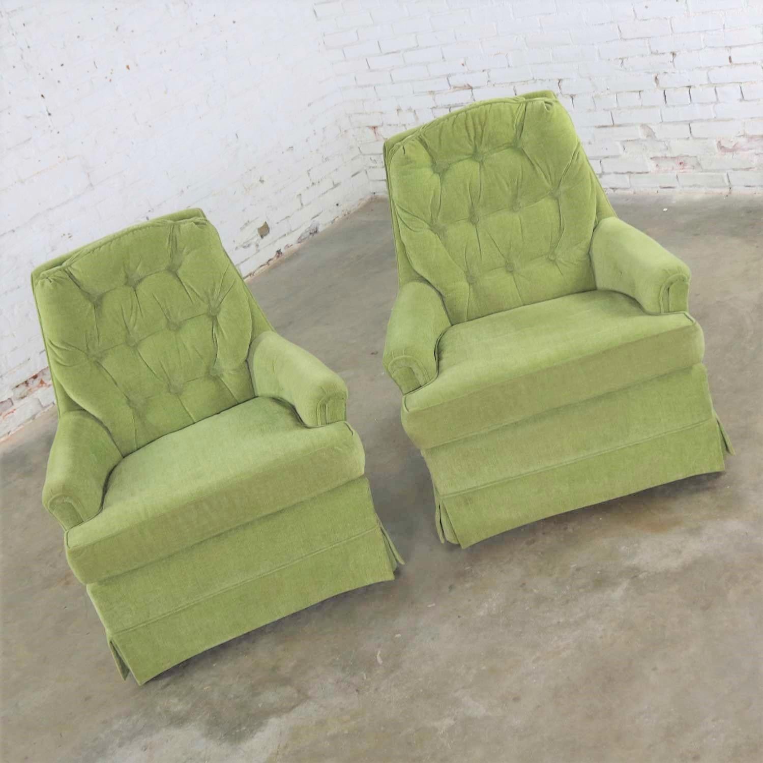 Comfy pair of chartreuse green velvet, button back, swivel, and rocking lounge chairs. They are in wonderful vintage condition. They wear their original upholstery which has been professionally cleaned and are ready to use. The fabric may have some