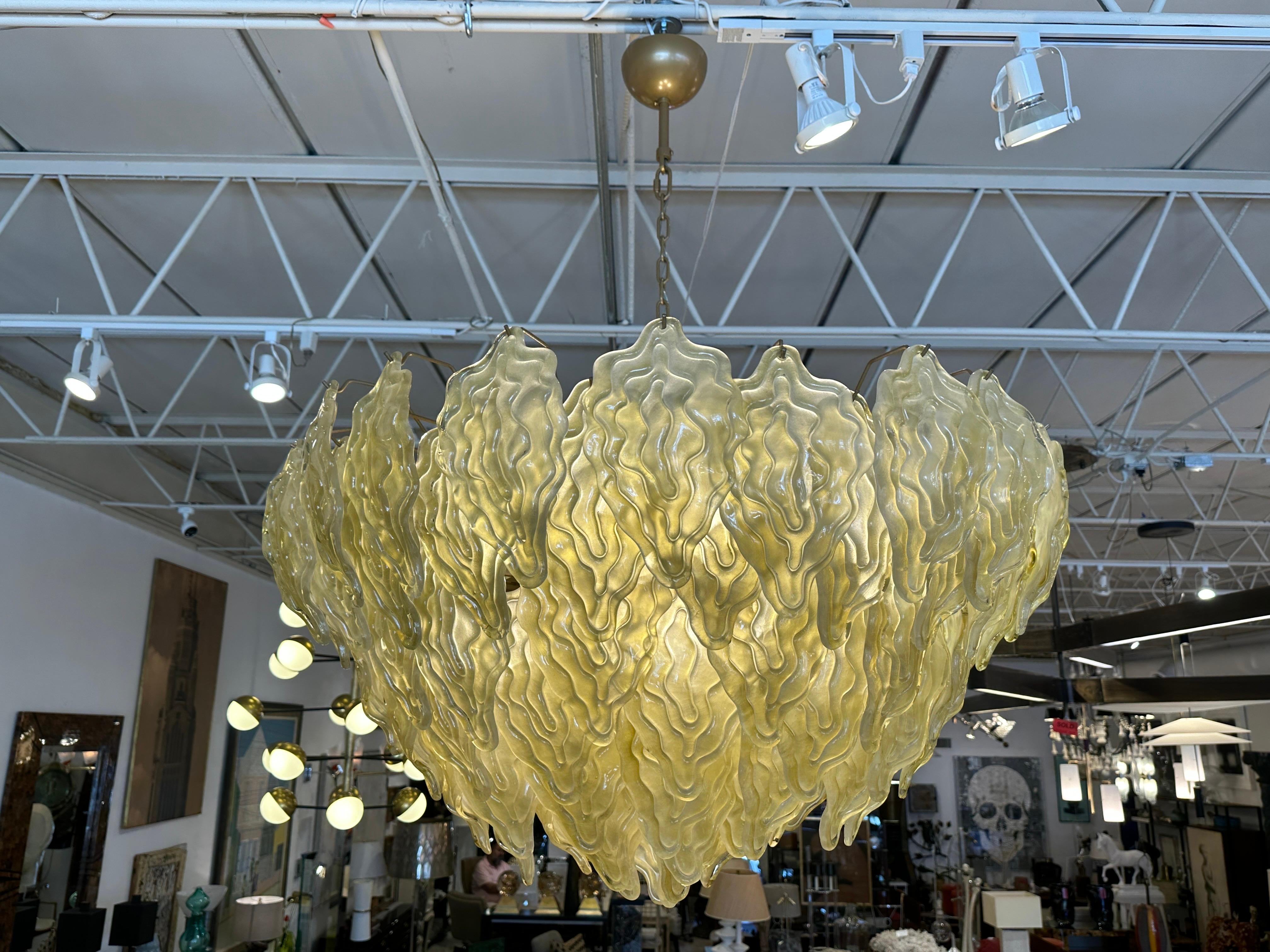 This is a wonderful 5-tiered chandelier descending to a point with dozens of chartreuse tone hand blown Murano glass leaves.  This fixture provides wonderful warm light and takes on a great color/ hue when off or illuminated.
NOTE: 5 Light bulbs
