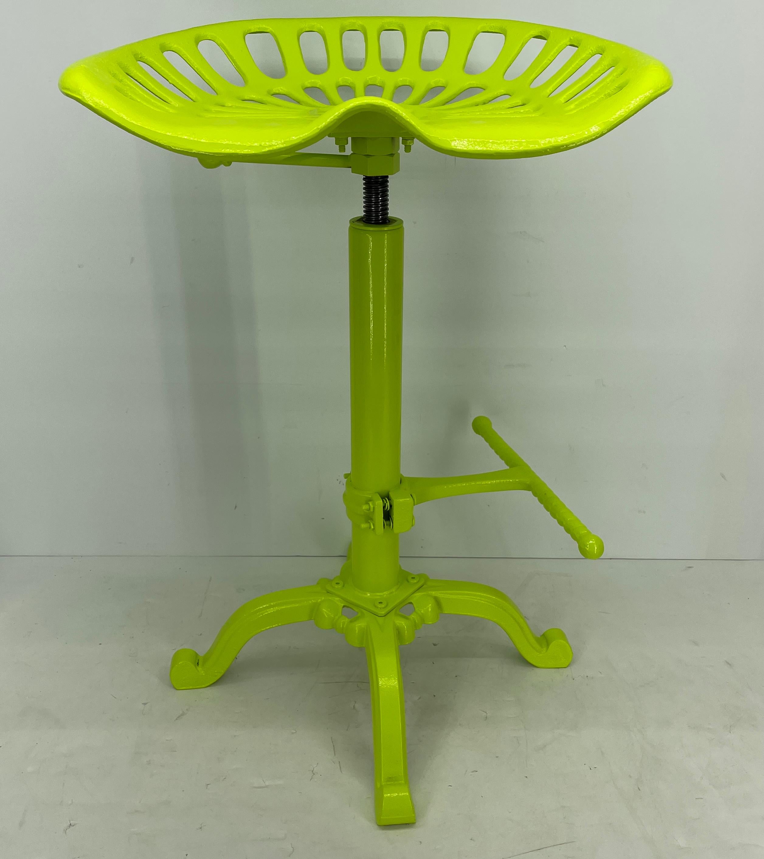 Industrial metal tractor seat stool newly powder coated in bright chartreuse. 
This bold and bright chartreuse tractor seat on a sturdy and adjustable swivel base is so much fun. The seat is counter height; comfortable and the adjustable base works